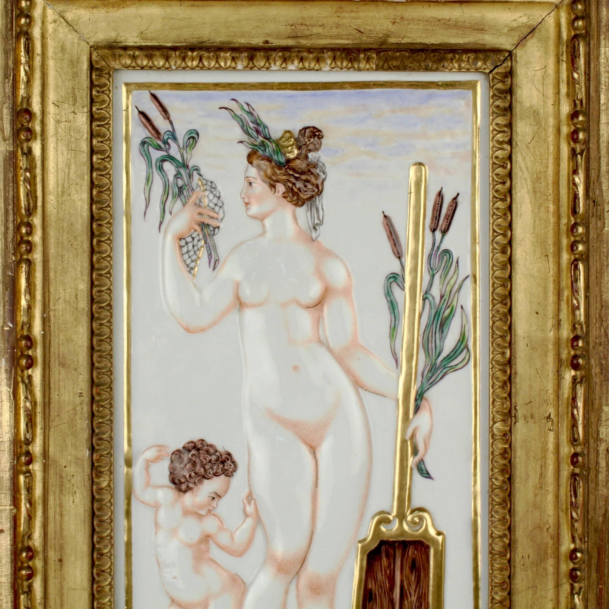 A fine and large-scale Capodimonte porcelain plaque depicting a Naiad (or a water nymph from Greek mythology). She is attended by a small cherub and holds cattails in her hands. The plaque is cast in relief and has polychrome painted decoration with