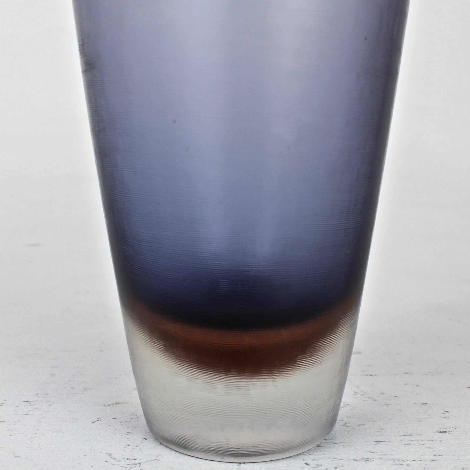 Paolo Venini designed "Inciso" glass vase with blue and brown colors under clear glass.

Base bears the three-line acid etched mark: "Venini Murano Italia".

Height: circa 8 1/4 in.

Items purchased from David Sterner