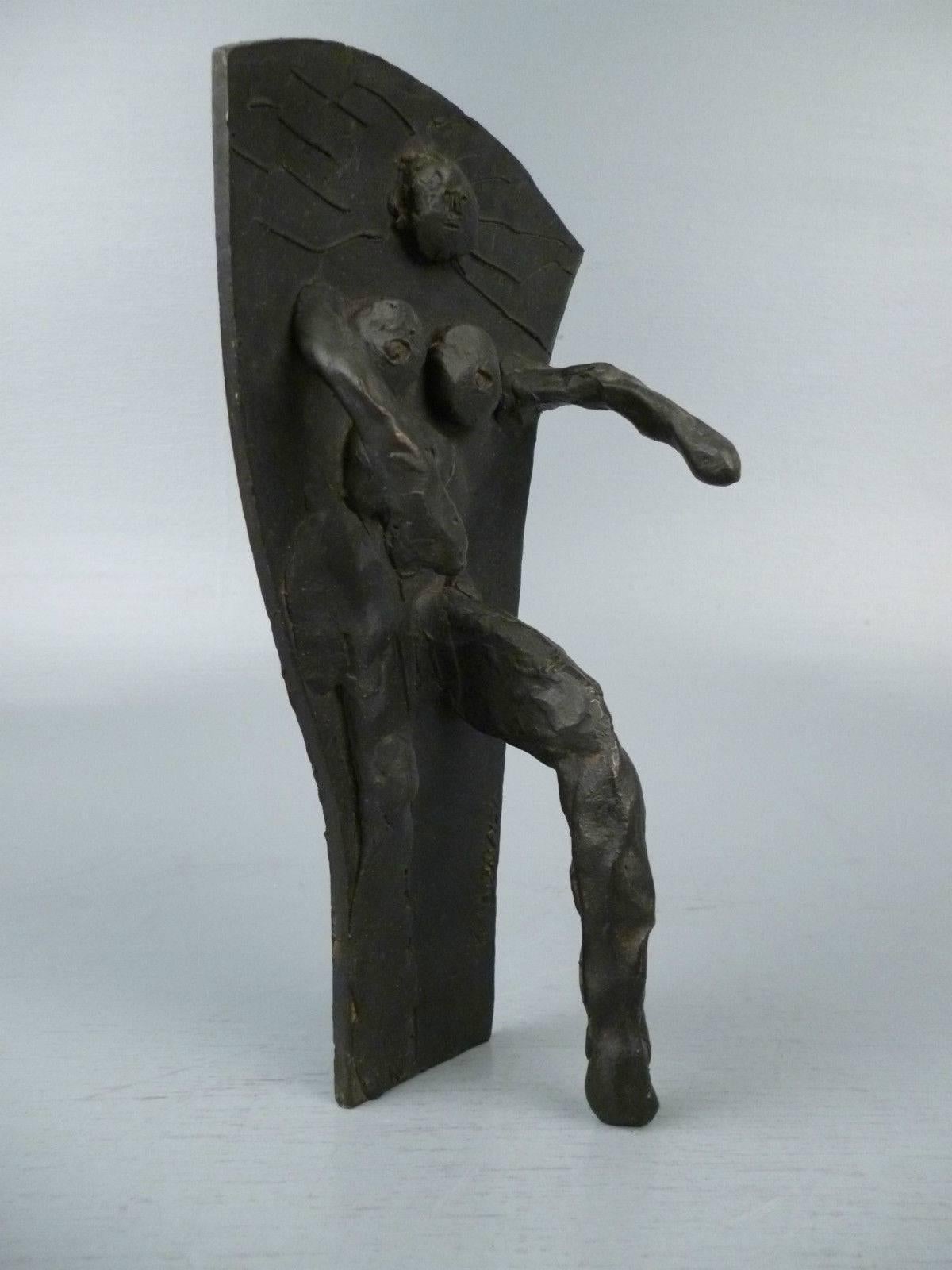 God - a small bronze sculpture by Abbott Lawrence Pattison. A strong feminist depiction of God as woman.

It depicts a nude female partial figure emerging from a flat surface. (When the bronze is on a table top, she looks to be swimming
