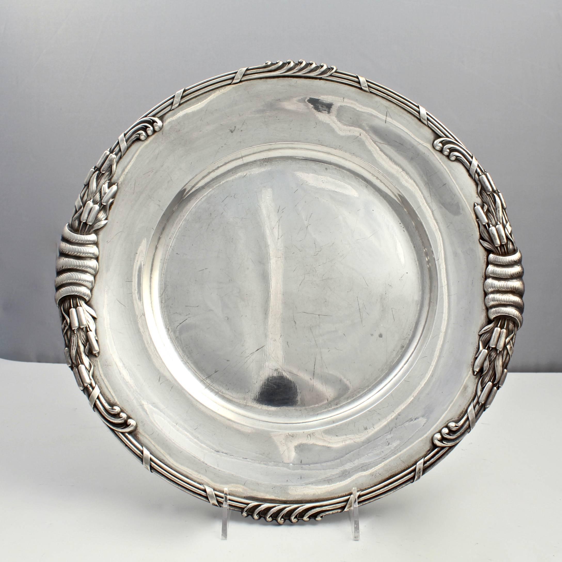 An incredibly heavy pair of period Art Nouveau Dutch sterling silver round serving trays from a large service by Ph. Saakes of the Hague. 

These pieces are likely from a commissioned service. Saakes was a Dutch gold and silversmith in the late