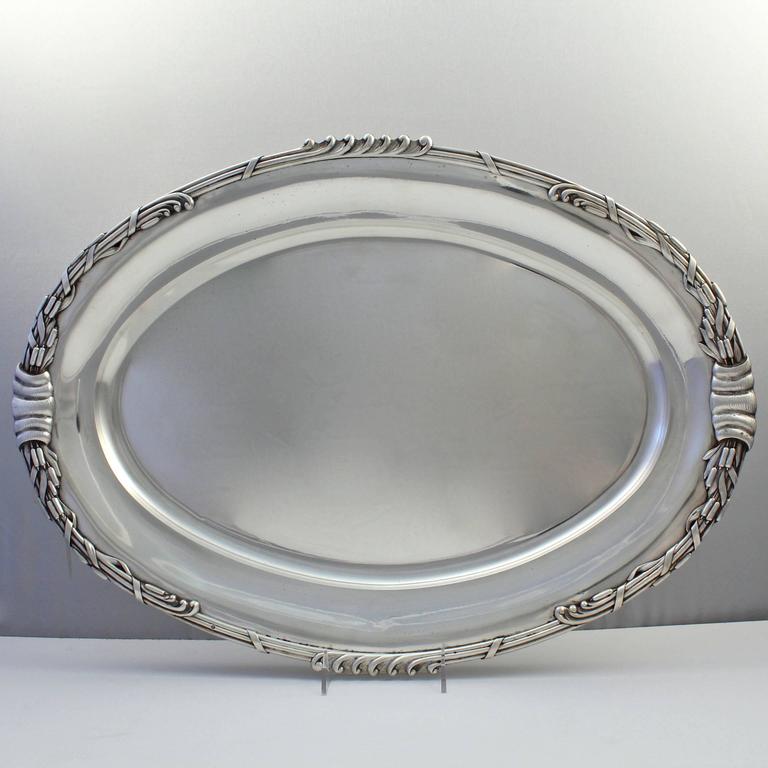 An incredibly heavy pair of period Art Nouveau Dutch sterling silver serving trays or platters from a large service by Ph. Saakes of the Hague. 

These pieces are likely from a commissioned service. Saakes was a Dutch gold- and silversmith in the