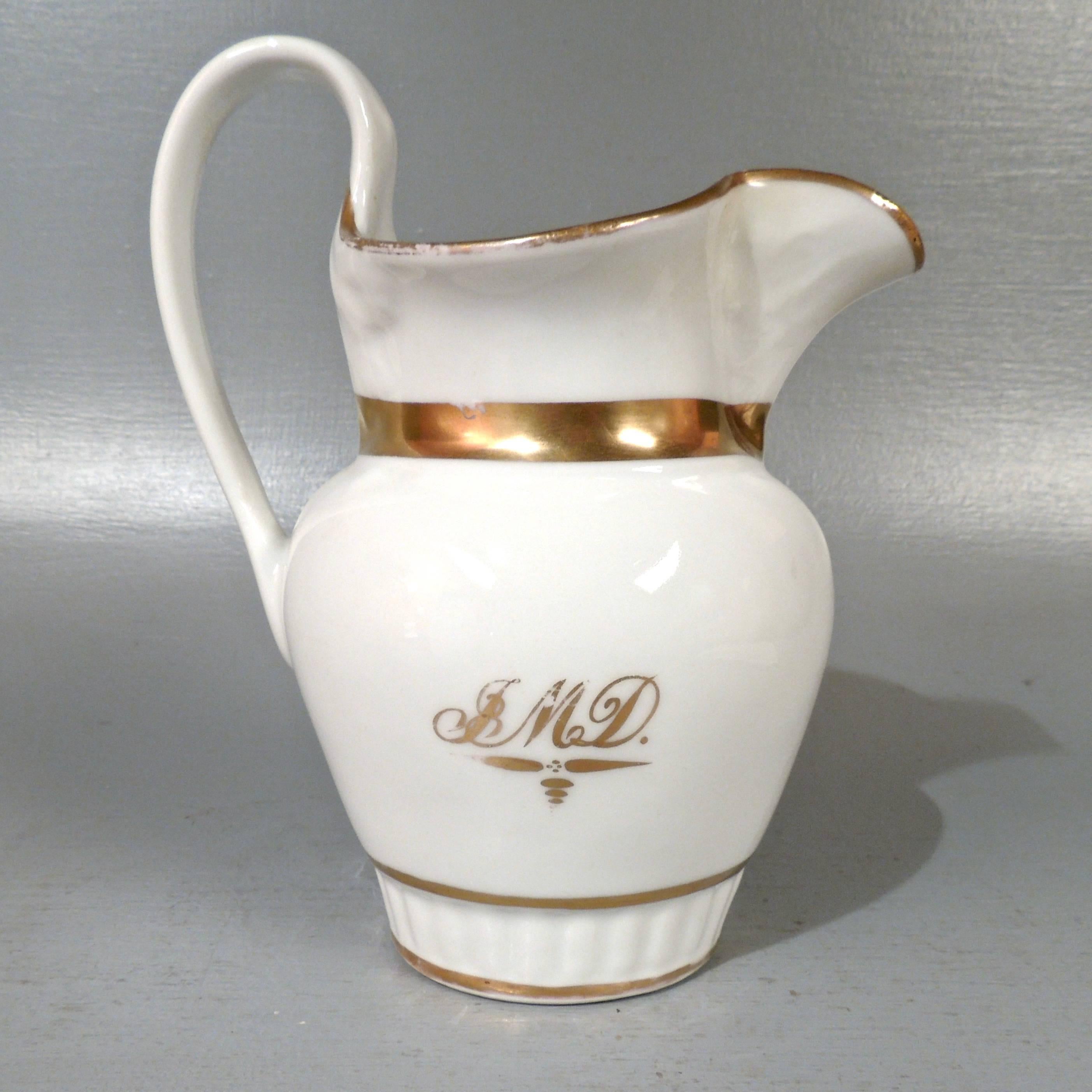 A fine and rare, early 19th century Tucker and Hemphill porcelain pitcher. 

Of Classic form with gilt owner’s monogram and gilt decoration. 
(It is accompanied by an estate note that identifies the original owner as John Martin Davis.)

Tucker