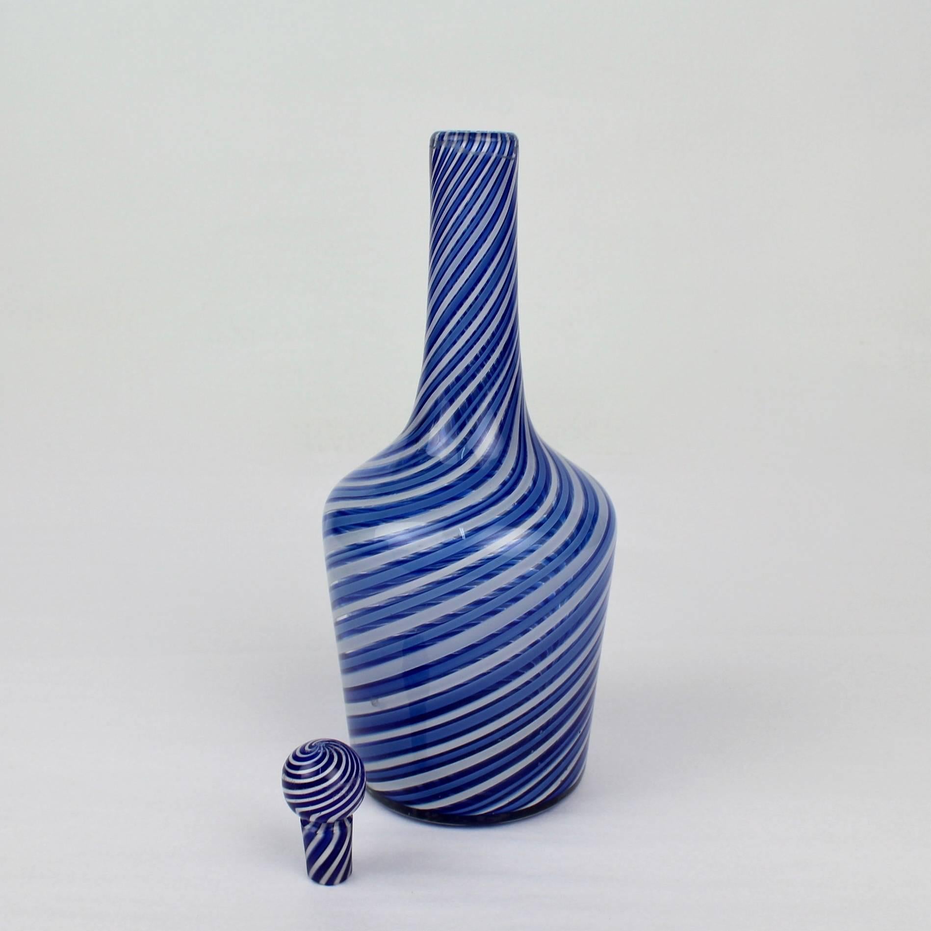A rare and visually compelling, diminutive decanter by the 19th century French glass house Clichy. 

Blue and white canes with a right hand twist comprise the decanter body with an elongated neck that capped by a marble size stopper. 

Base