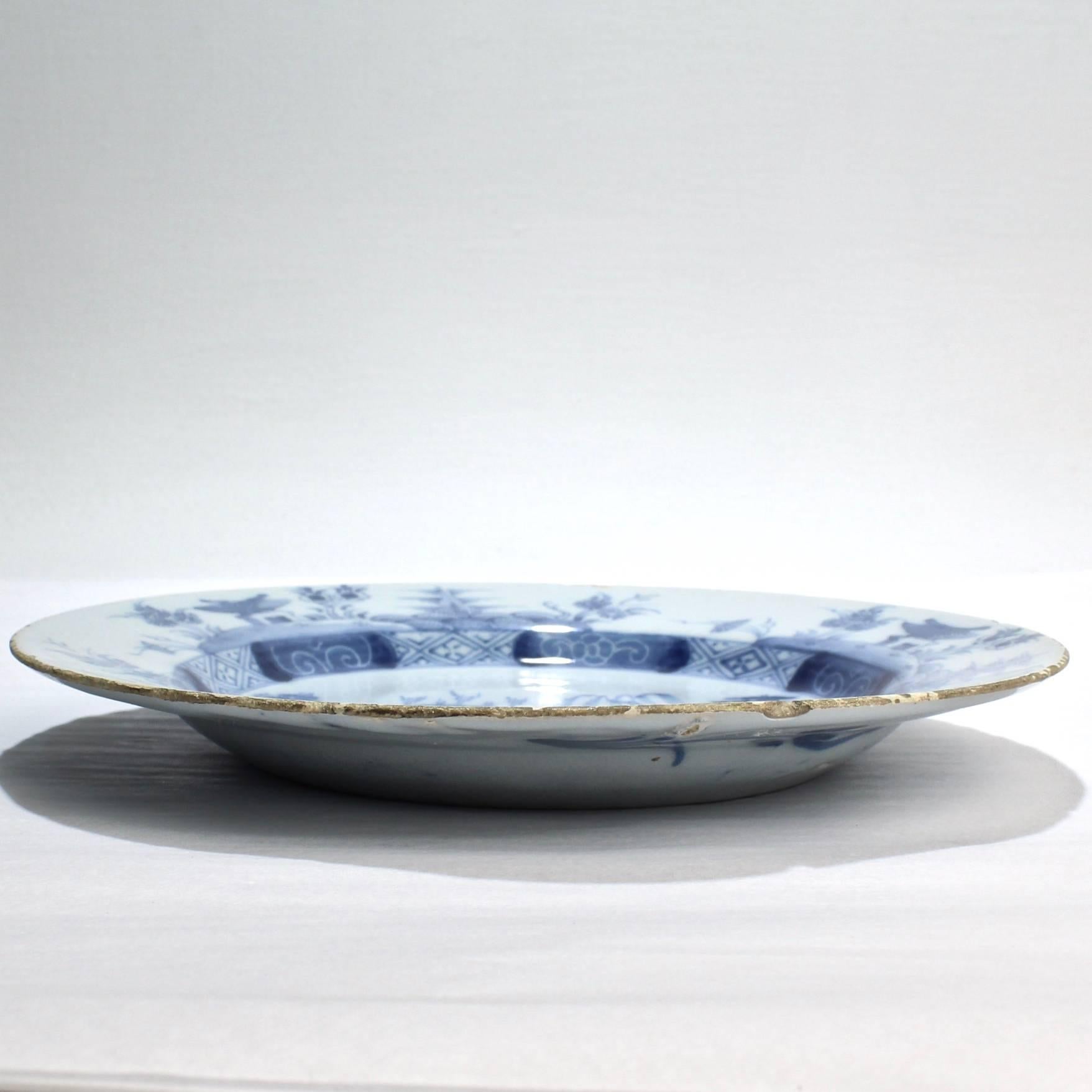 A fine example of 18th century Dutch delft pottery. 

Chinese landscape design with stylized dragons on the reverse.

Diameter: circa 8 3/4 in.

Items purchased from David Sterner antiques must delight you. Purchases may be returned for any