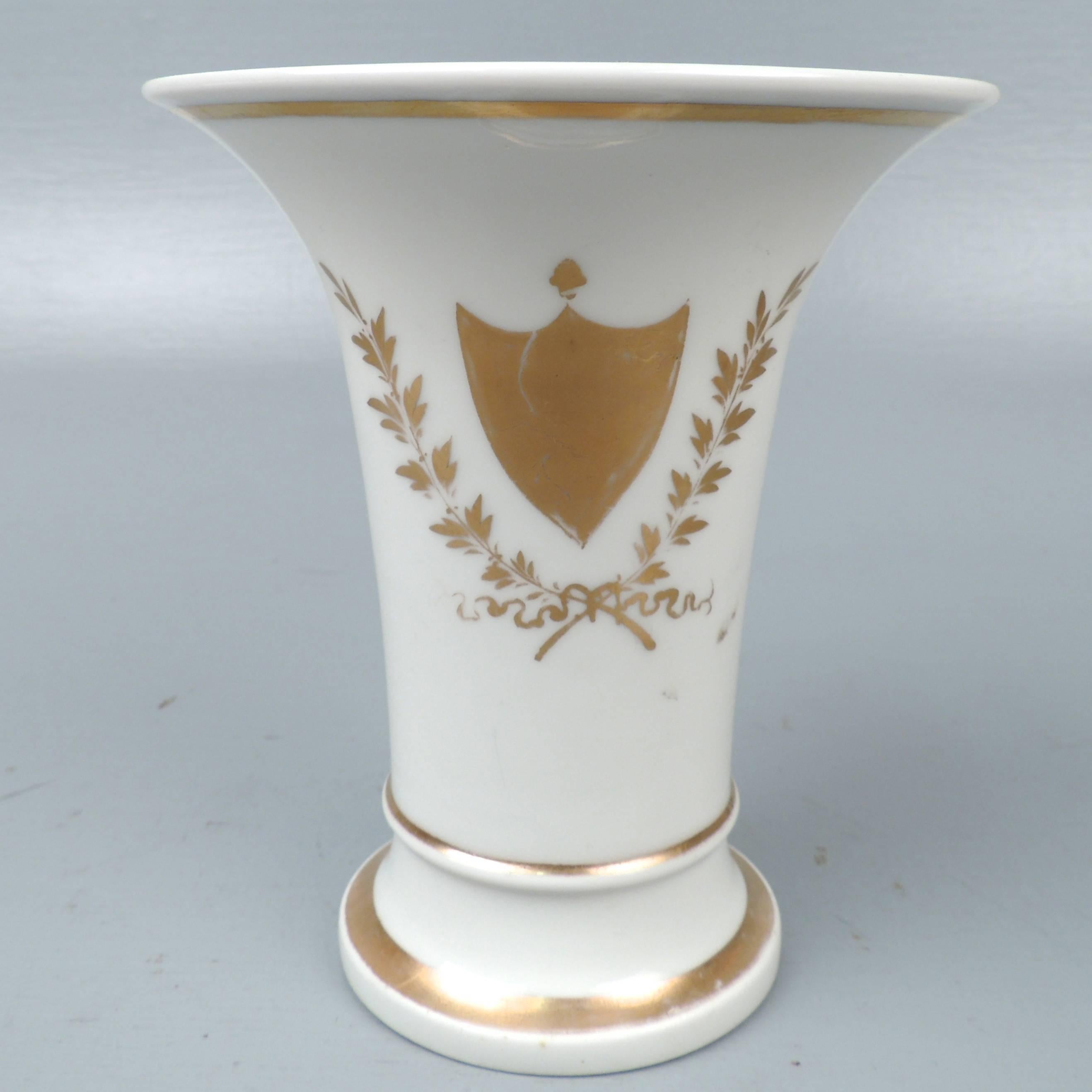 A fine and rare early 19th century Tucker and Hemphill porcelain vase.

The vase is decorated with a gilt shield device surrounded by leaf and branch and ribbon decoration. (Also, note how the shield is reminiscent of Tucker's famous perfumes!)