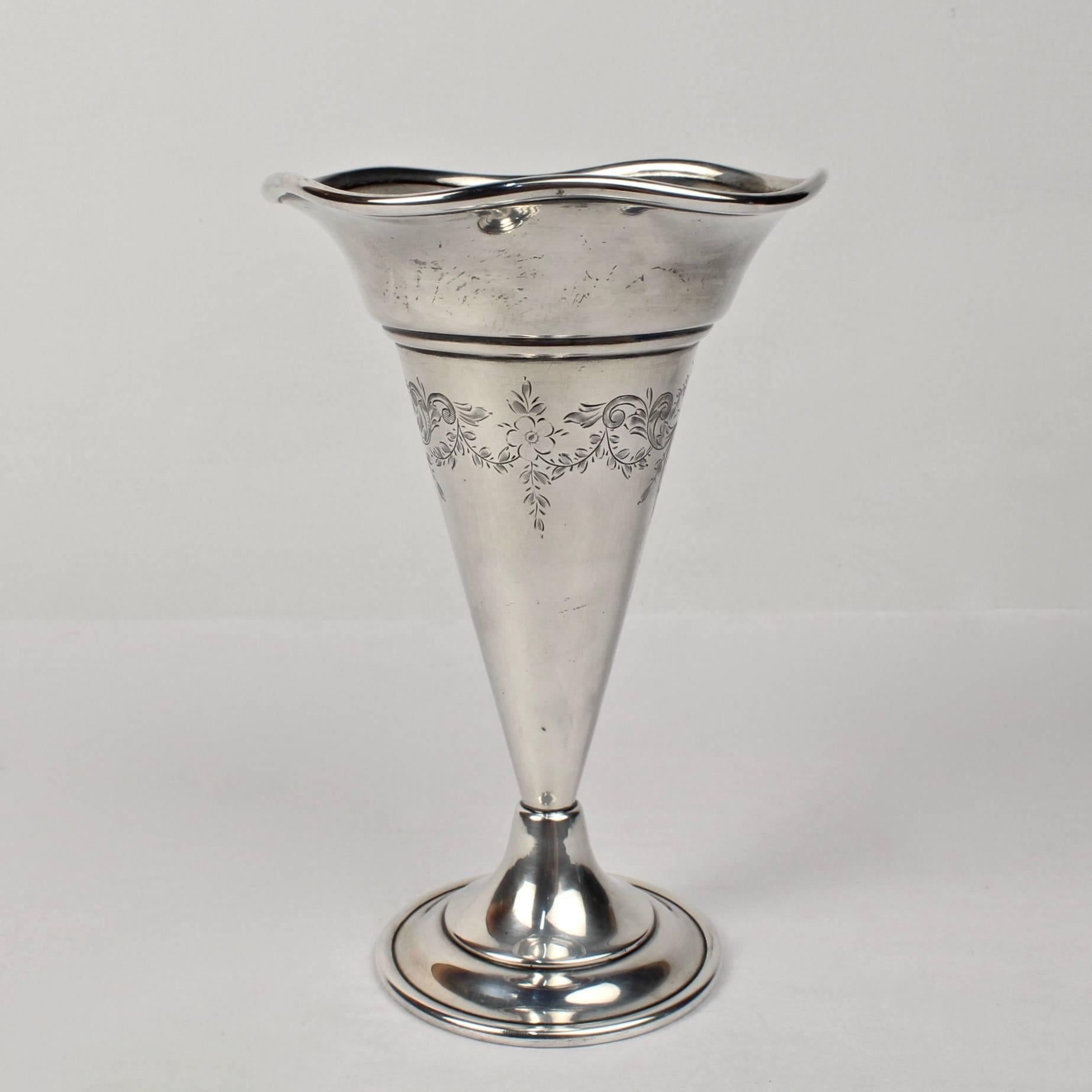 A good antique trumpet form flower vase with flaring, scalloped rim and Fine engraving to the body. 

Produced by George Henckel & Co. (high quality New York Silversmiths) in the early part of the 20th century. 

Height: ca. 7 in.

Items