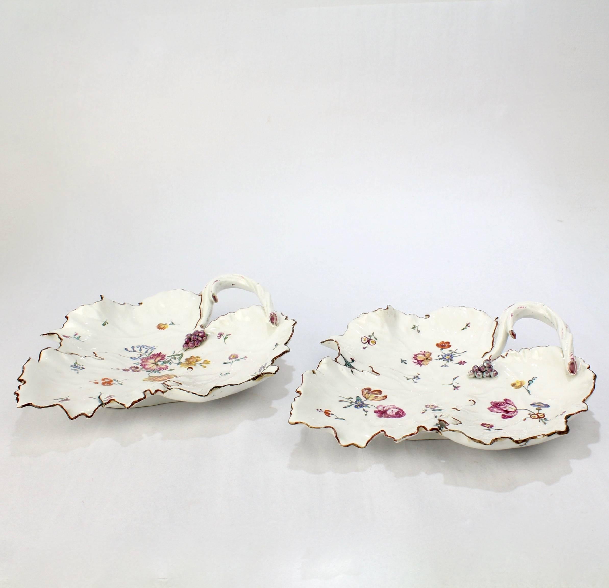 A fine rare pair of mid-18th century Frankenthal leaf dishes.

Having figural applied grapes near the handle and enamel decorated flowers throughout.

Condition: There are some chips and fritting to the edges, firing cracks both concealed with