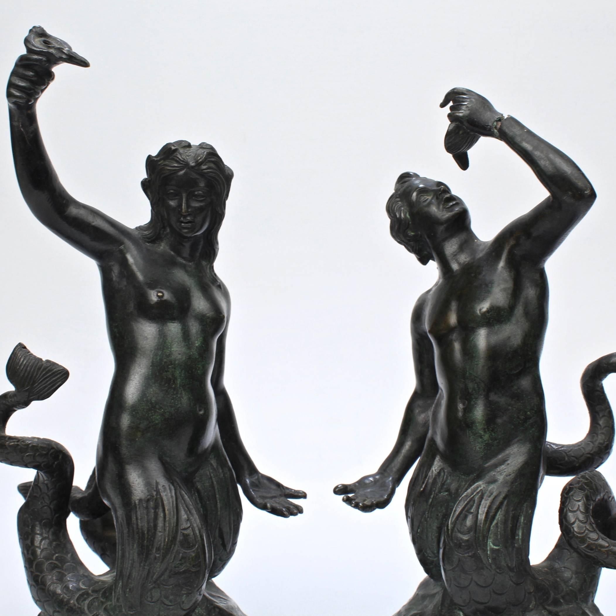 A fine pair of grand tour fountain sculptures.

Depicting a mermaid and merman, each small sculpture appears to be a functional miniature fountain with copper tubing.

The merman has a split to his arm near the wrist.

Height Mermaid: ca. 9
