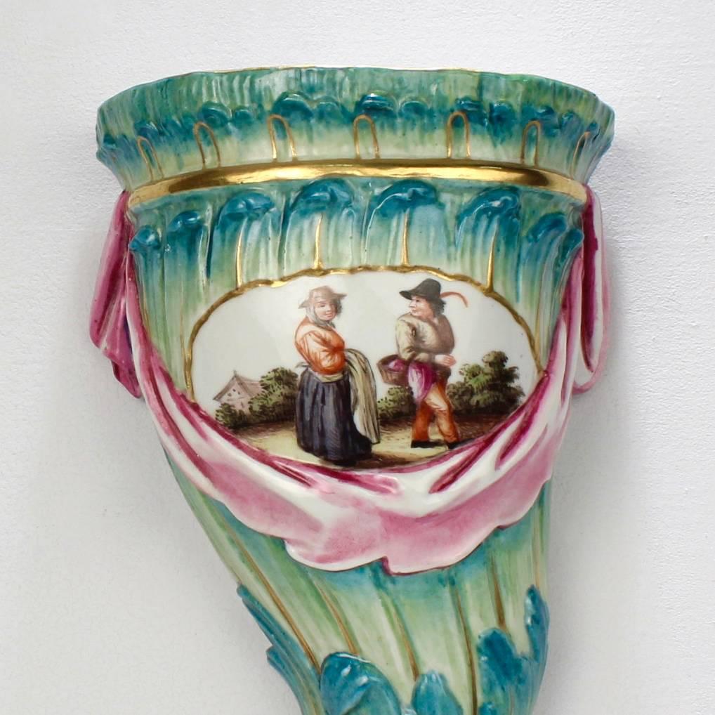 A rare, antique German porcelain wall bracket or wall shelf in greens and pink. A perfect companion for period Objets d'Art. 

Of the late Rococo period and marked for Wallendorf Porcelain factory.

With a hand-painted floral spray to the top