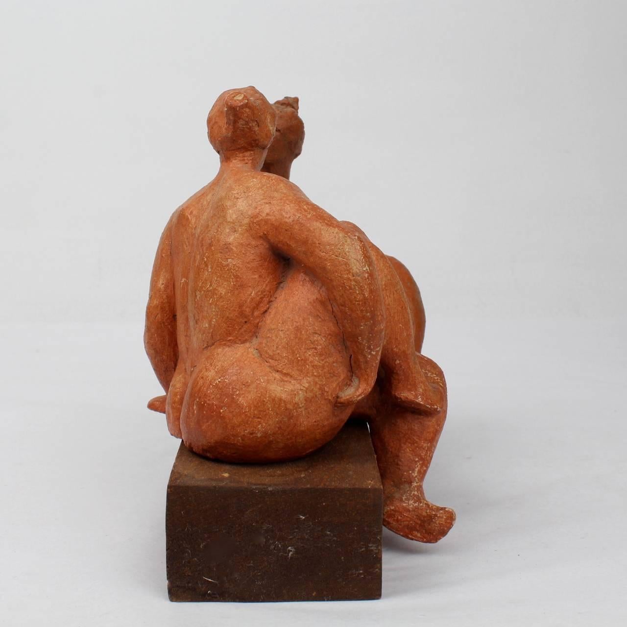 A modernist group of two terracotta sculptures by F. Kahn.

Depicting two plump women posed in conversation. Terrific whimsy and style. 

Placed on a wooden block that is integral to the work. Painted with a orange-red wash.

Signed 'F. Kahn'