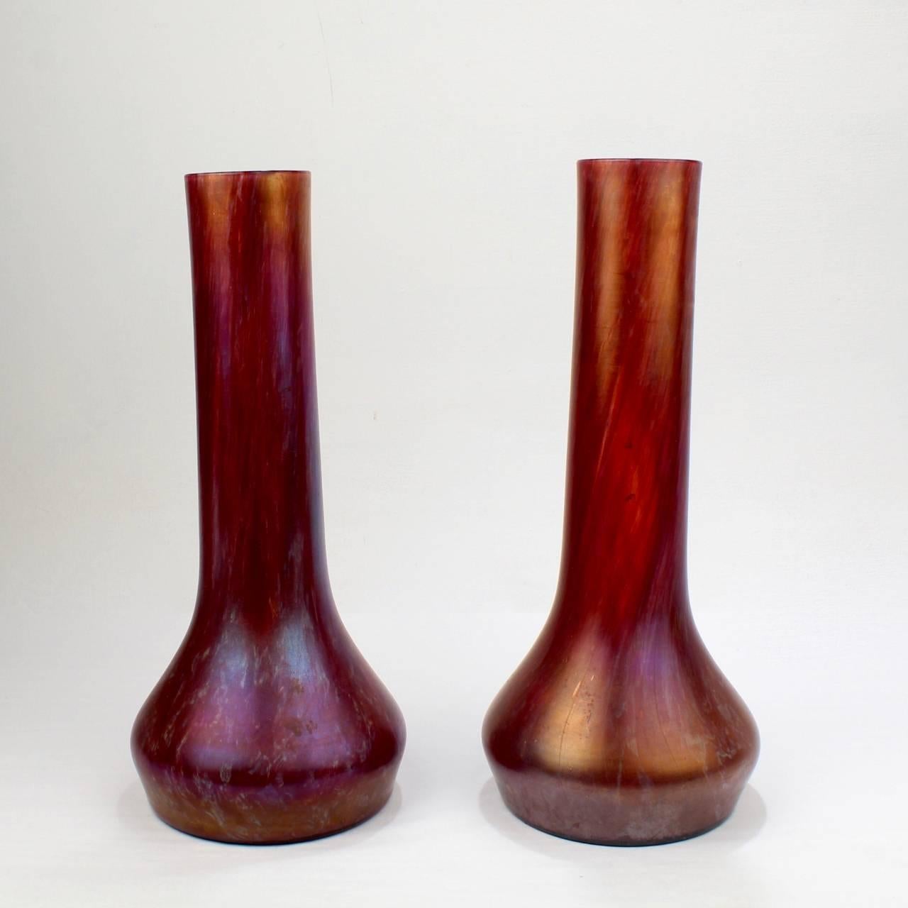 A fine pair of Loetz type Art Nouveau or Jugendstil vases with an internal red oil spot decoration and a lightly iridescent surfaces. 

Attributed to the Czech glass manufacturer Josef Rindskopf and Sons. 

Height: ca. 12 in.

Items purchased