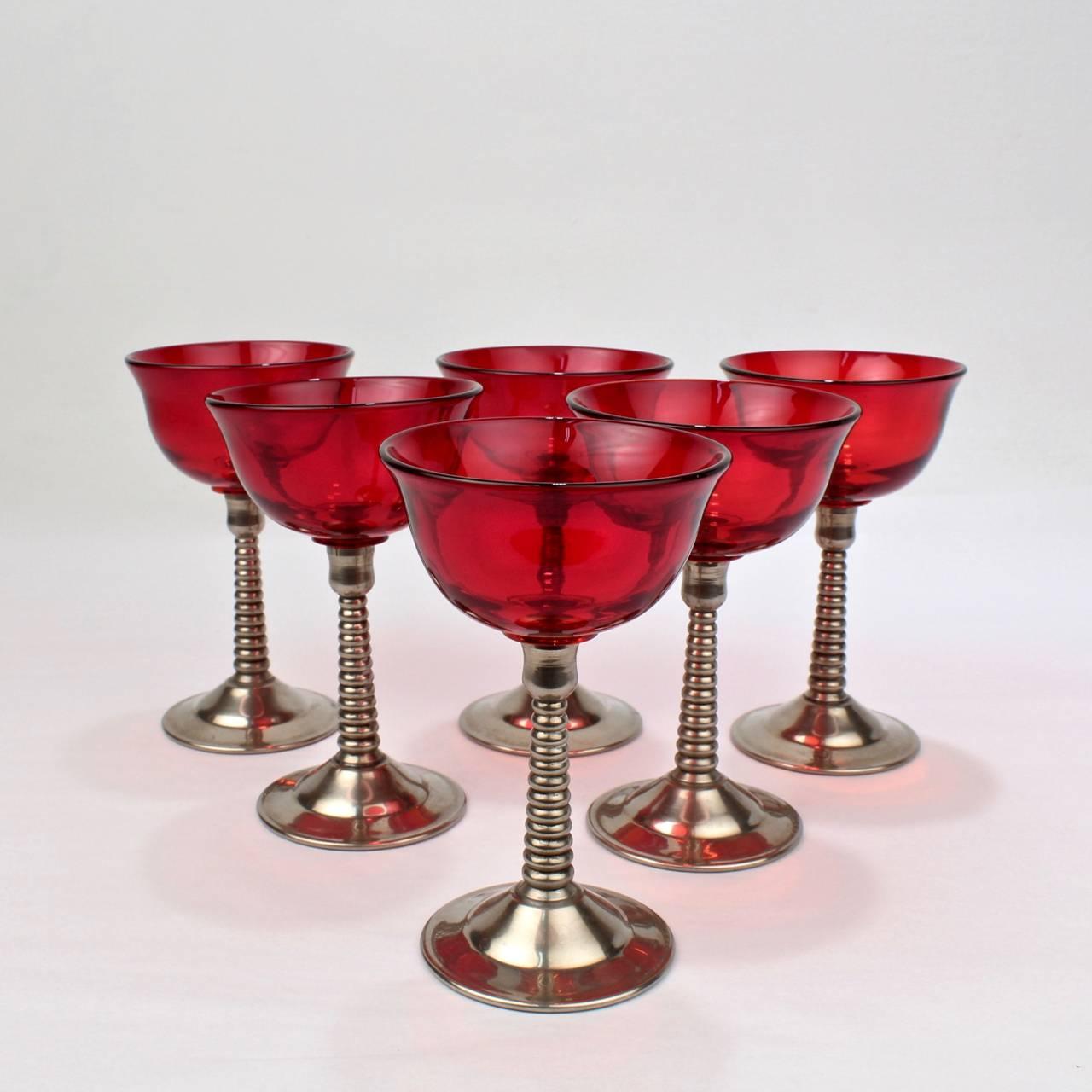A terrific set of 6 Machine Age silver plate and red glass cocktail glasses by Lehman Brothers. Perfect for a Martini.

Dating to the 1930s or 1940s.

With screw in glass inserts.

Height: circa 5 in.

Items purchased from David Sterner