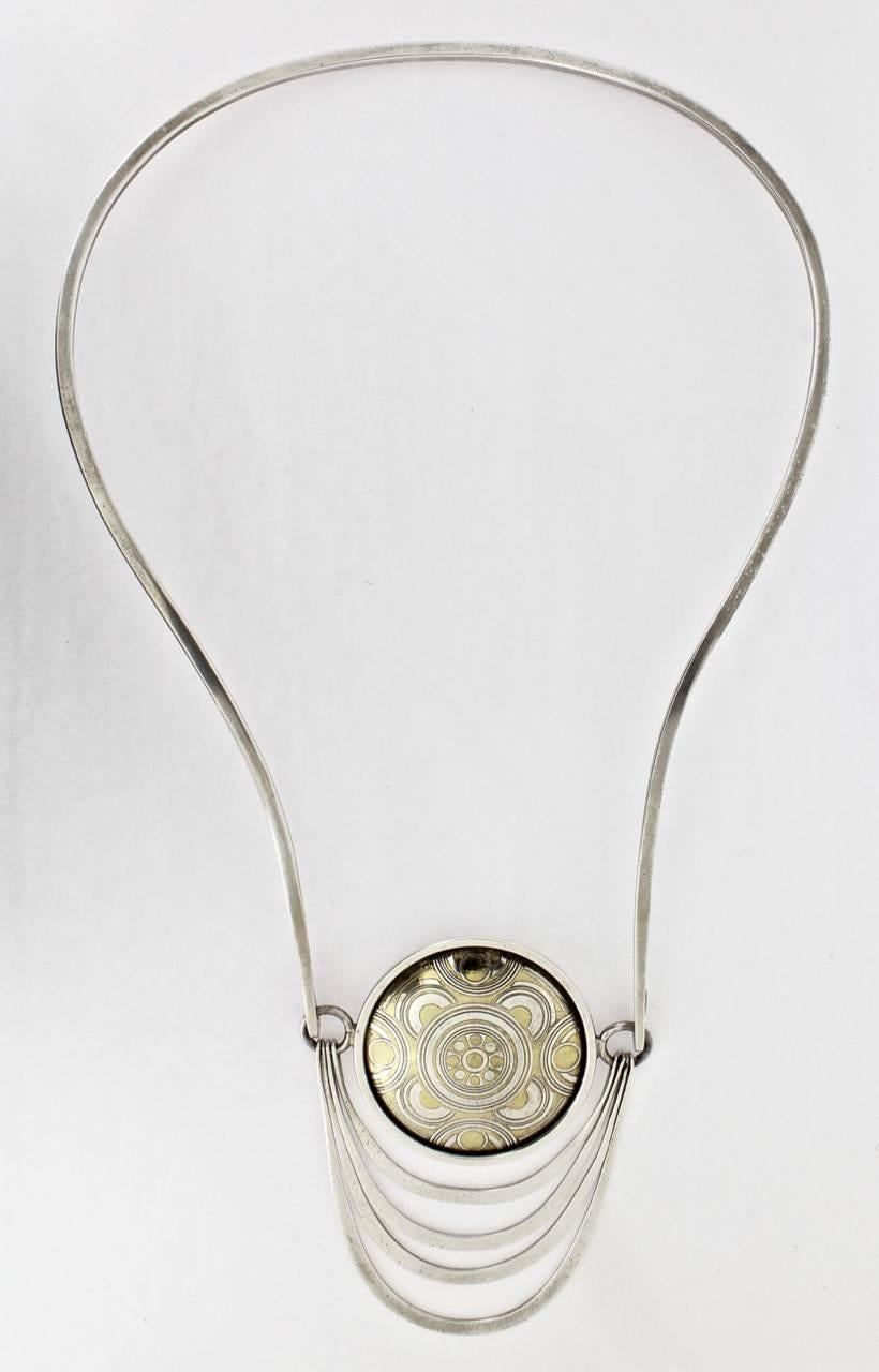 Mary Ann Scherr designed this modernist necklace as part of the Signature V Collection in 1975 for Reed & Barton. In addition to Mary Ann Scherr's works, the collection included pieces by Arline Fisch, Glenda Arentzen, Ronald Hayes Pearson, and