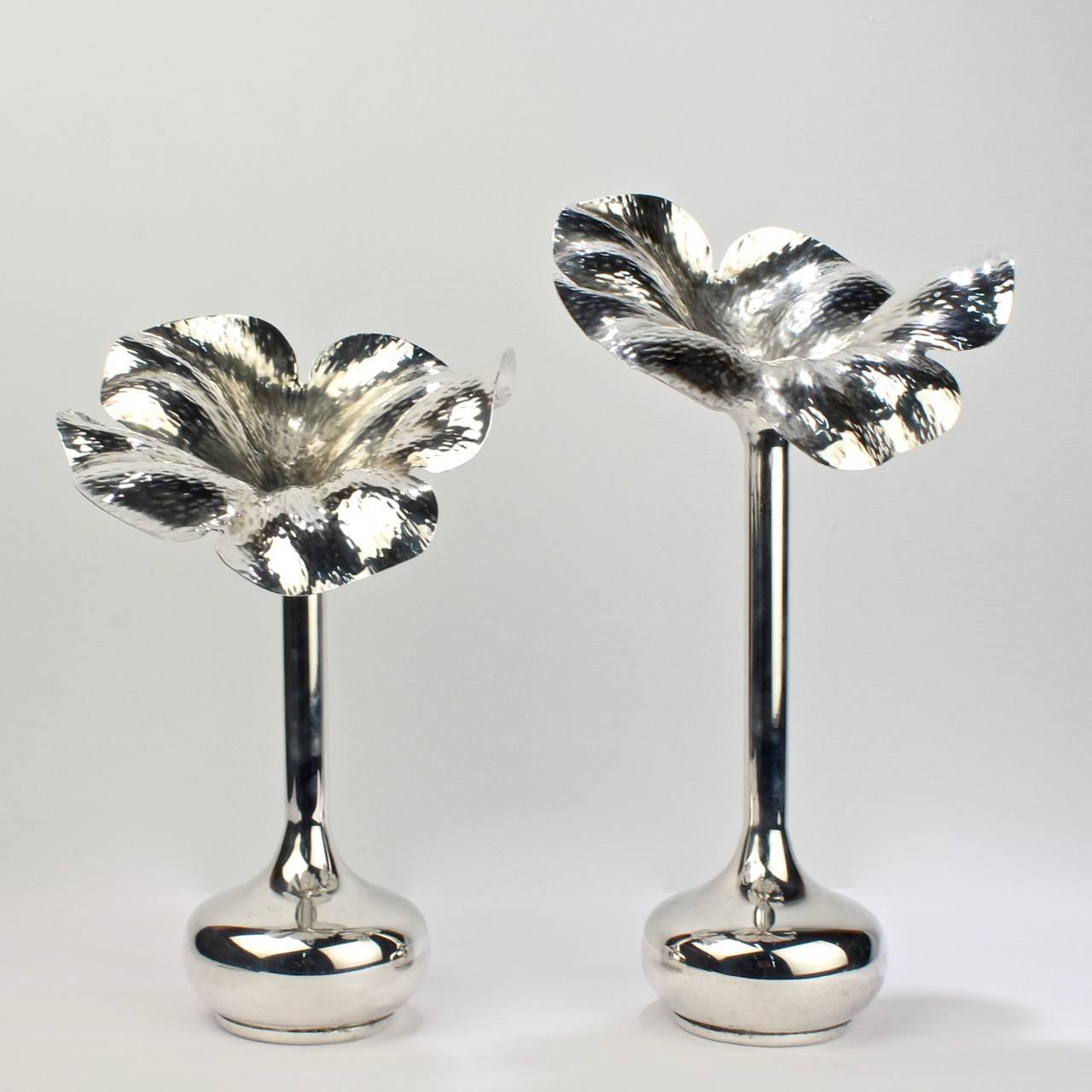 A fine pair of large modernist silver plated flower vases by the Brazilian designer Marilena Mariotto. 

Each with a bulbous base, elongated neck, and wonderful hand hammered (almost explosive) stylized floral tops. 

Signed to the bases:
