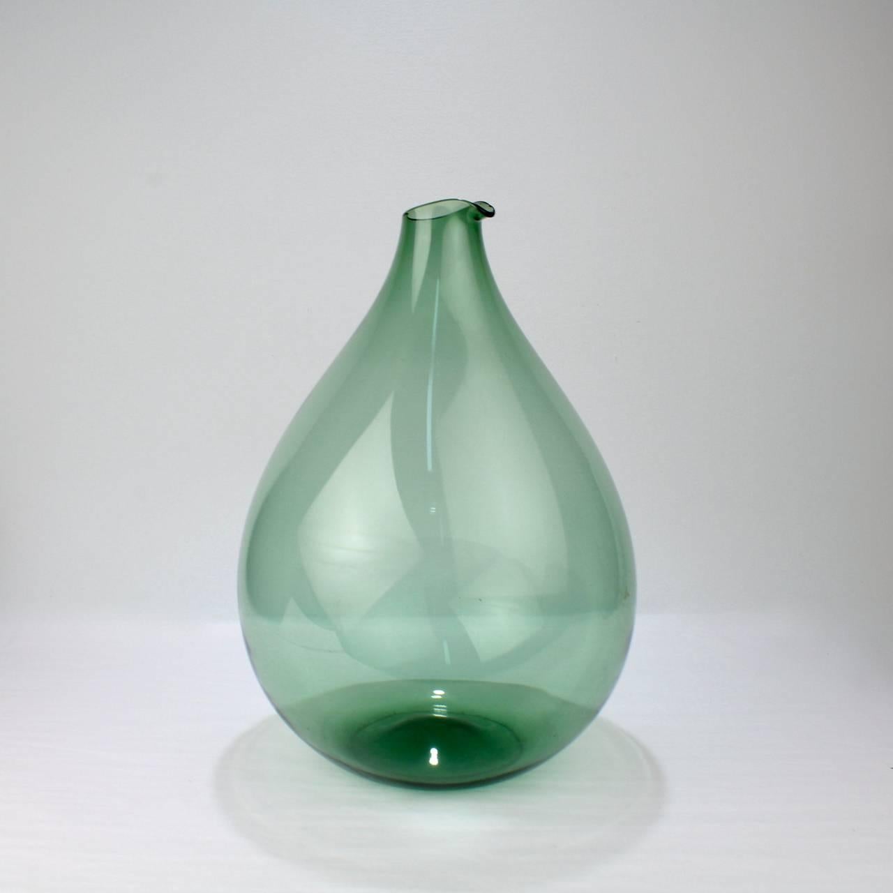 A fine and large scale Bomkulla jug by Kjell Blömberg in green.

Designed for Gullaskruf in the early 1960s.

Height: ca. 14 1/2 in.

Interior retains some persistent light spotting and mineral stains from water.

Items purchased from David