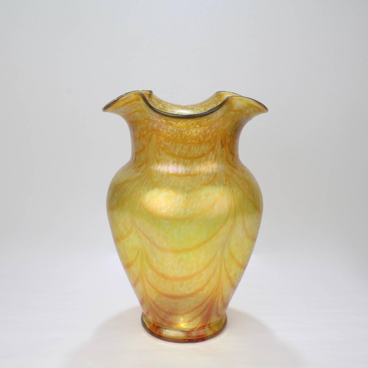A very large gold and orange iridescent Art Nouveau art glass vase designed by Otto Thamm for the Fritz Heckert Glass Manufactory.

Prior to 2014, this pattern was thought to be silberband by Kralik. Thanks to scholarship by Volkmar Schordt, we