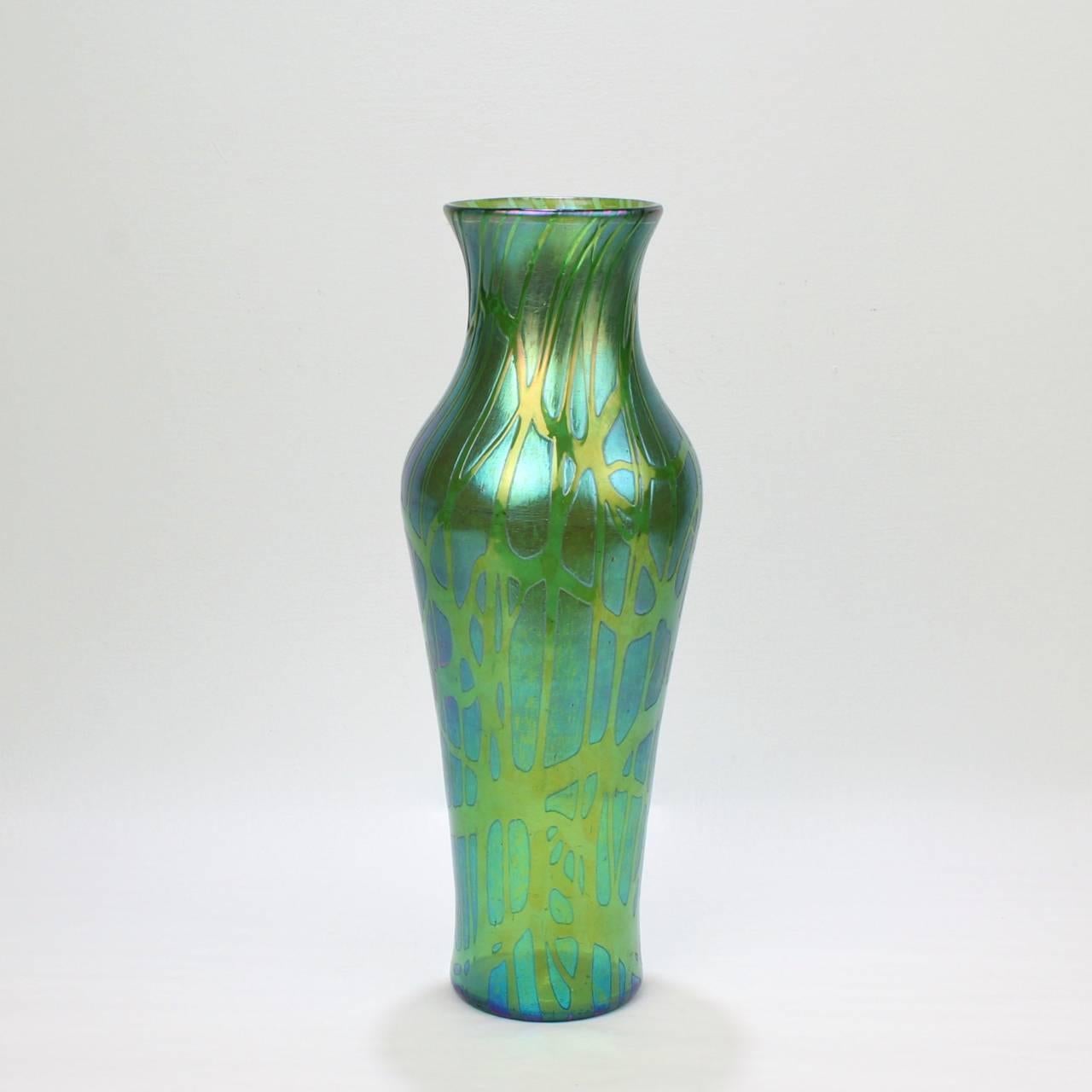 A good, large early 20th century Loetz art glass vase. 

With a vasiform body and pulled thread and green Crete Pampas decoration.

Measures: Height ca. 13 3/4 in.

Items purchased from David Sterner Antiques must delight you. Purchases may be
