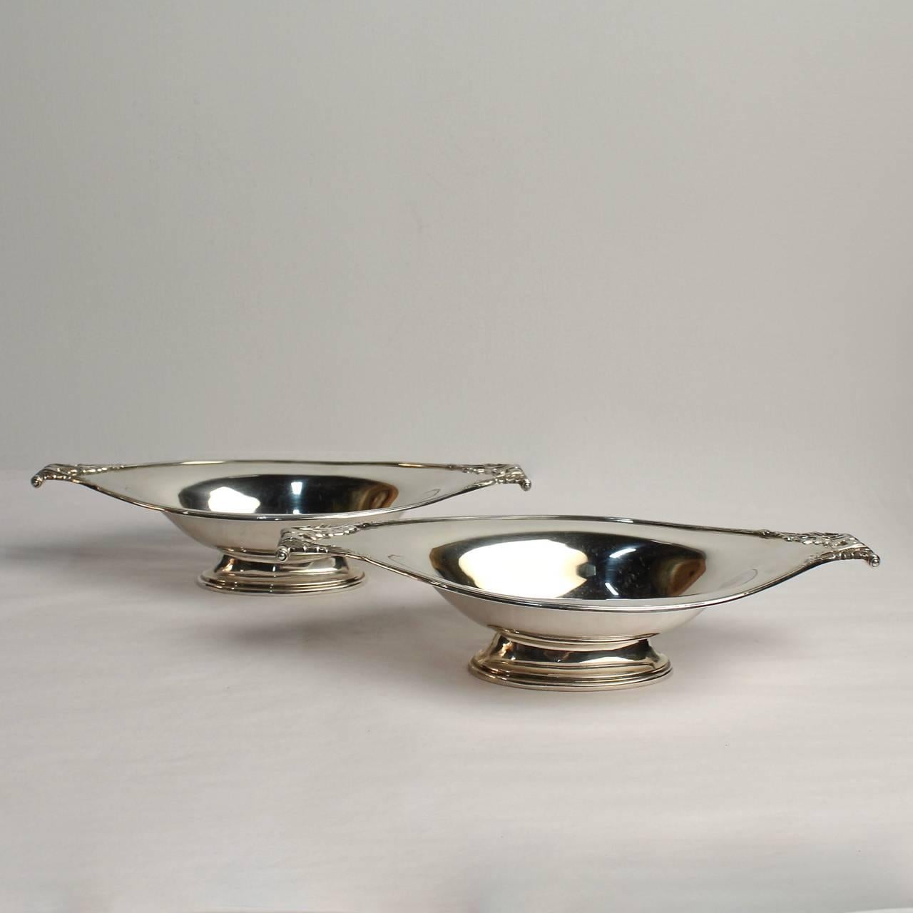 A fine pair of sterling silver scroll handle English sterling silver bowls by Wilson and Sharp. 

Marked for London and 1915.

Wilson & Sharp was the partnership of Robert Wilson and Andrew Sharp and was established in 1889. They ran shops and
