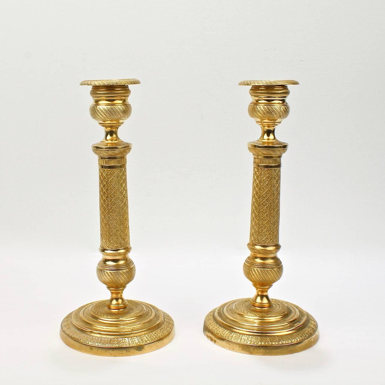 A pair of finely cast French Empire style candlesticks in doré gilt bronze.

Height: circa 9 3/4 in.

Items purchased from David Sterner antiques must delight you. Purchases may be returned for any reason for a period of 7 days.
 