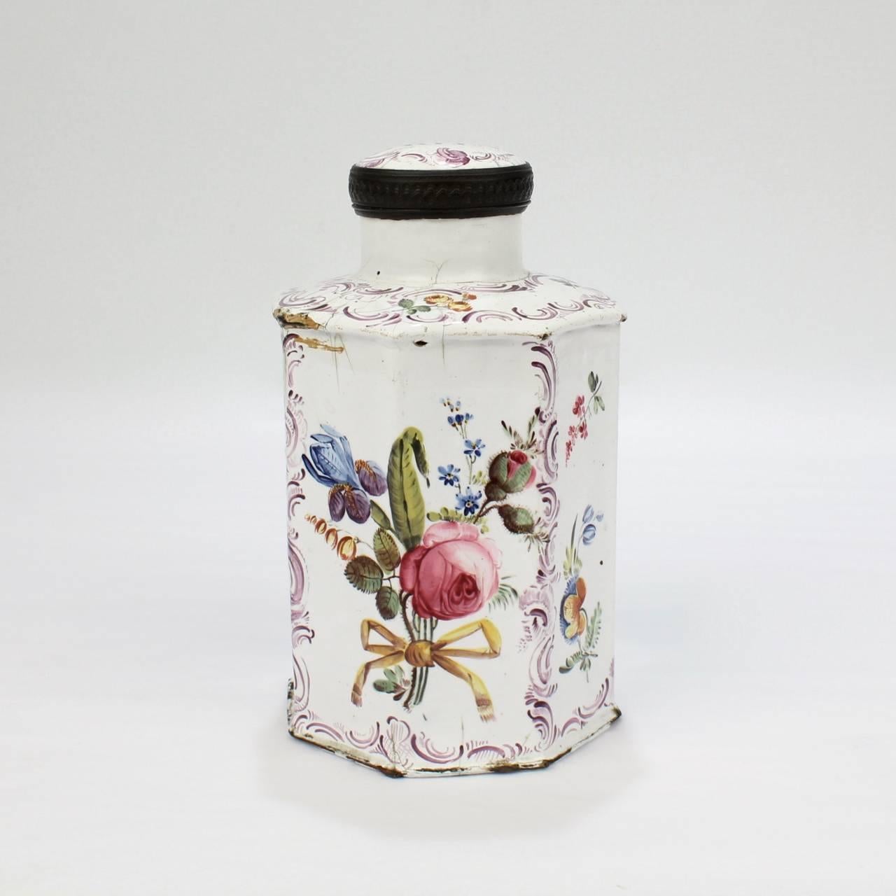 A rare, 18th century English Bilston or Battersea enamel green tea caddy.

Likely manufactured in South Staffordshire.

Of octagonal form with a white enamel on copper. Decorated with floral bouquets and sprays, bows, and purple swags. The top
