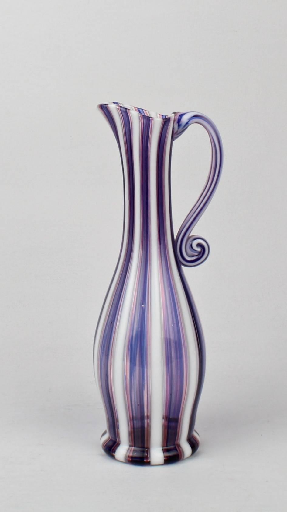 A fine Venetian pink (or red), white and blue a canne glass ewer or pitcher.

Likely by Salviati. 

With an applied, S scroll handle of the same canes.

Height: ca. 10 1/8 in.

Items purchased from David Sterner Antiques must delight you.