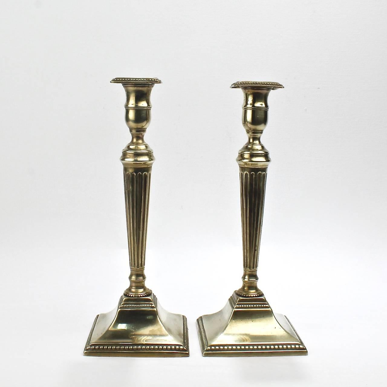 A fine pair of George III brass candlesticks.

Having integral bobeches, fluted and tapered supports, and beaded bases.

Height: ca. 10 1/2 in.

Items purchased from David Sterner Antiques must delight you. Purchases may be returned for any