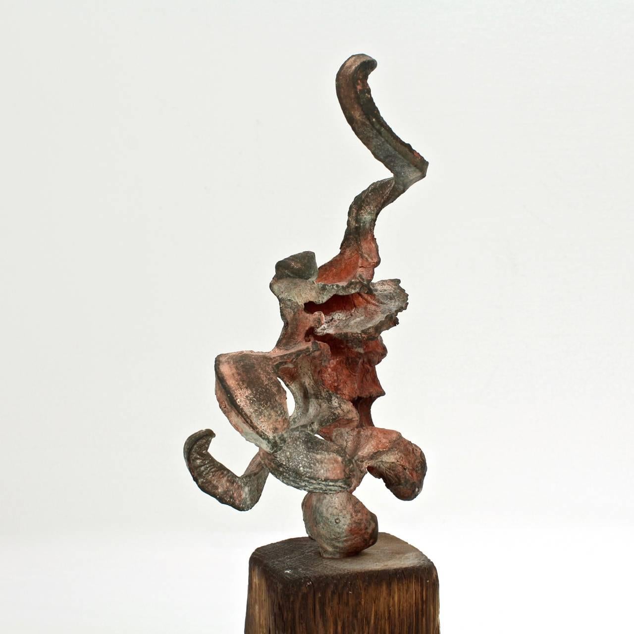 A Squeeze sculpture.

Steve Tobin (b. 1957)

From a series of Squeeze bronzes created by Tobin in the late 1990s.

A patinated and painted bronze sculpture mounted on an aged, charred integral wooden plinth.

Signed Tobin under