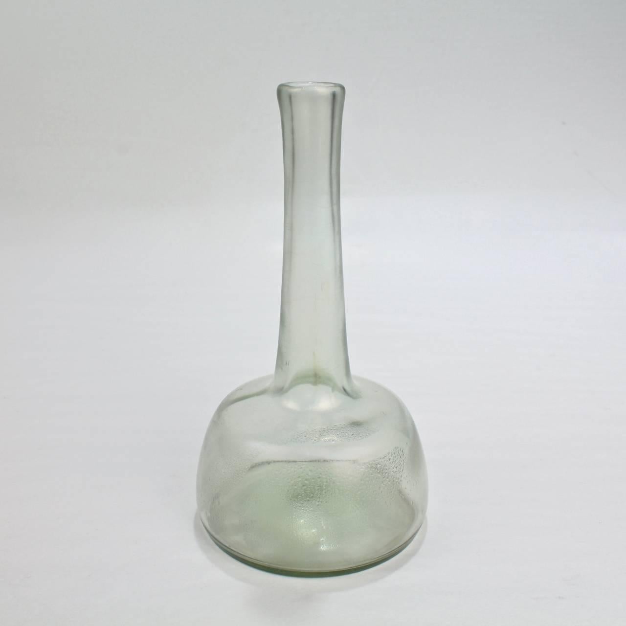 A fine, diminutive antique Loetz art glass vase in the rare Olympia Glatt pattern.

Leaning heavily on early Roman glass styles, this pattern in particular illustrates the Art Nouveau fascination with the glass of the Antique period. All the top