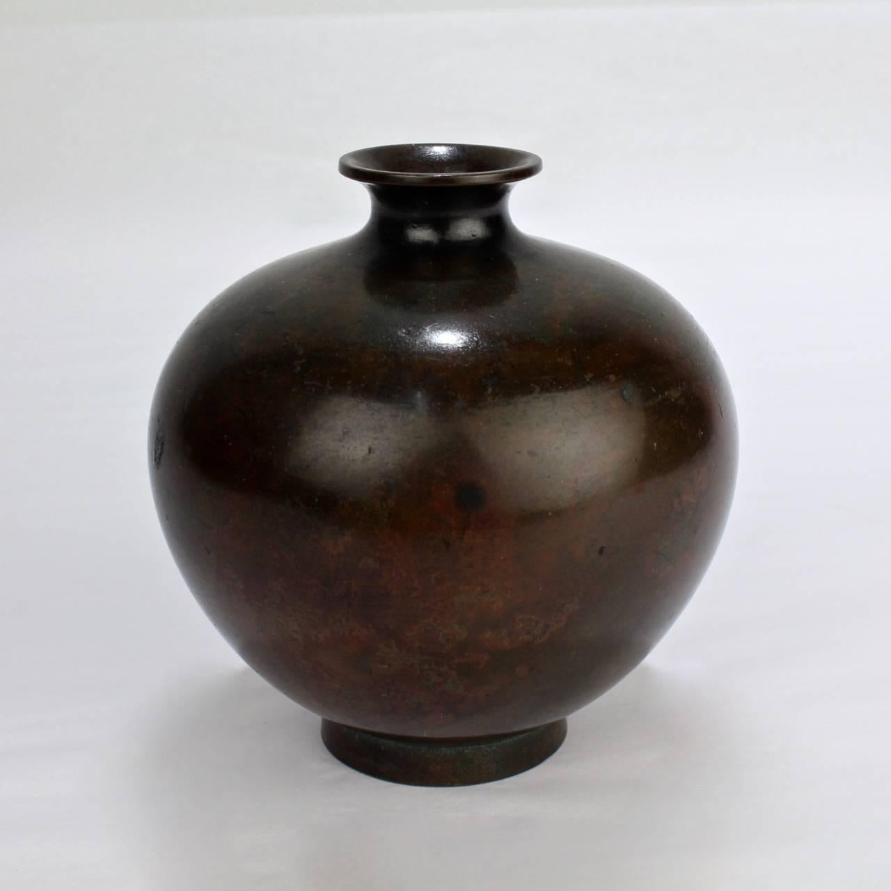 A diminutive, antique Meiji Period Japanese bronze vase.

Of bulbous form and flared mouth supported by a round foot.

With fine mottled patina.

Height: circa 3 3/4 in.

Items purchased from David Sterner antiques must delight you.