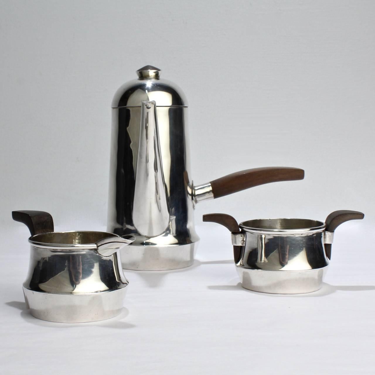A fine and rare hand-wrought William Spratling sterling silver espresso or demi-coffee set.

Comprising of a side-handled coffee pot, creamer and sugar. Each with rosewood handles.

Each piece has all the expected (and wished for) indices and