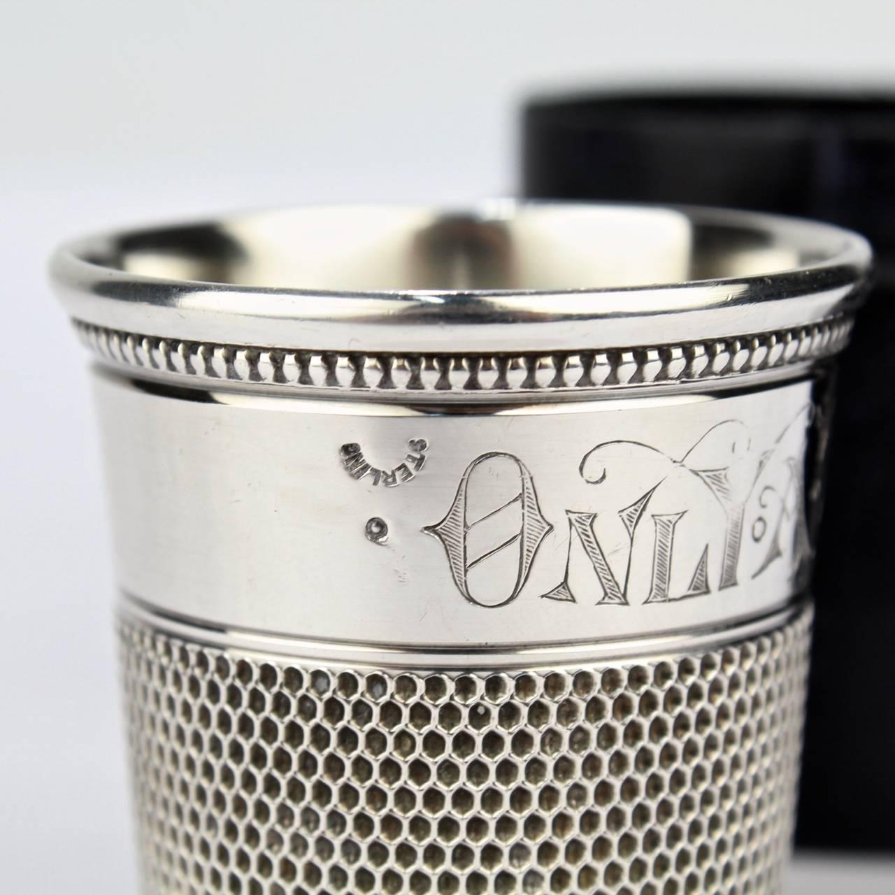 An engraved antique sterling silver 'Only a Thimble Full' cocktail measure or shot glass.

Manufactured by Simmons Bros. of Philadelphia in the form of a very large figural thimble during the roaring 1920s.

Retains its original box.

Height: