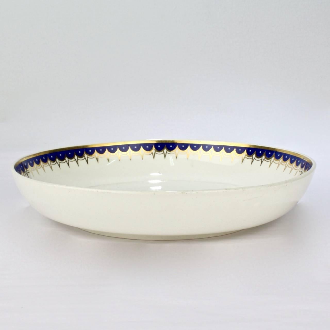 A rare group of wedgwood creamware bowls.

In the neoclassical pattern no. 892 with a cobalt blue and gold border.

Diameters: just under 9 in., just over 8 3/4 in., and just over 7 3/4 in.

The reverse of each bears impressed factory