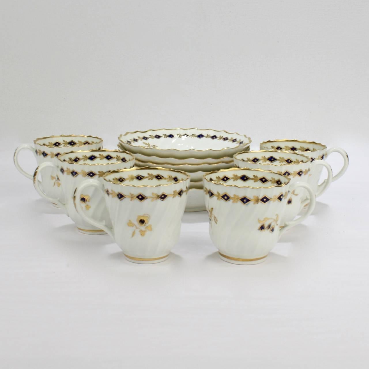 A set of six antique Flight Worcester porcelain cups and saucers.

Each with a ribbed swirl design and cobalt blue and gold floral sprig and garland decoration.

Each base is marked with a blue underglaze crescent and script Flight