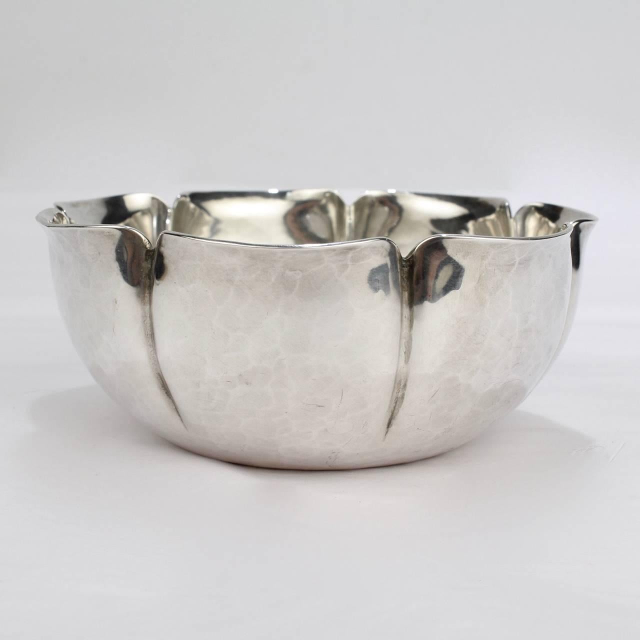 A good, heavy gauge American Arts & Crafts sterling silver bowl.

In a stylized, lobed floral form.

Handmade by Joel F Hewes. Hewes was active in Titusville, New Jersey in the first half of the 20th century. 

Base stamped: HANDMADE / JOEL F