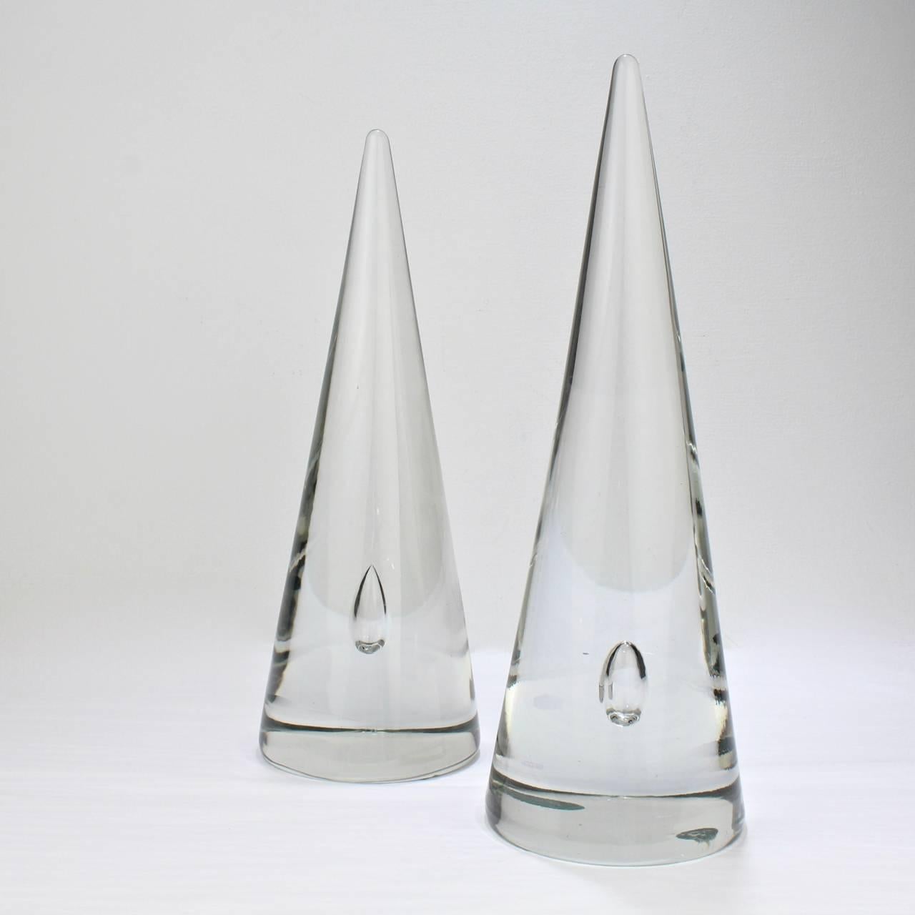 A good, assembled pair of Barbini glass cones. 

Simple lines that are perfect for a Modern interior.

Each has a captured bubble centered in interior near the base.

Both bear an etched Barbini signature at the base of each cone.

Heights:
