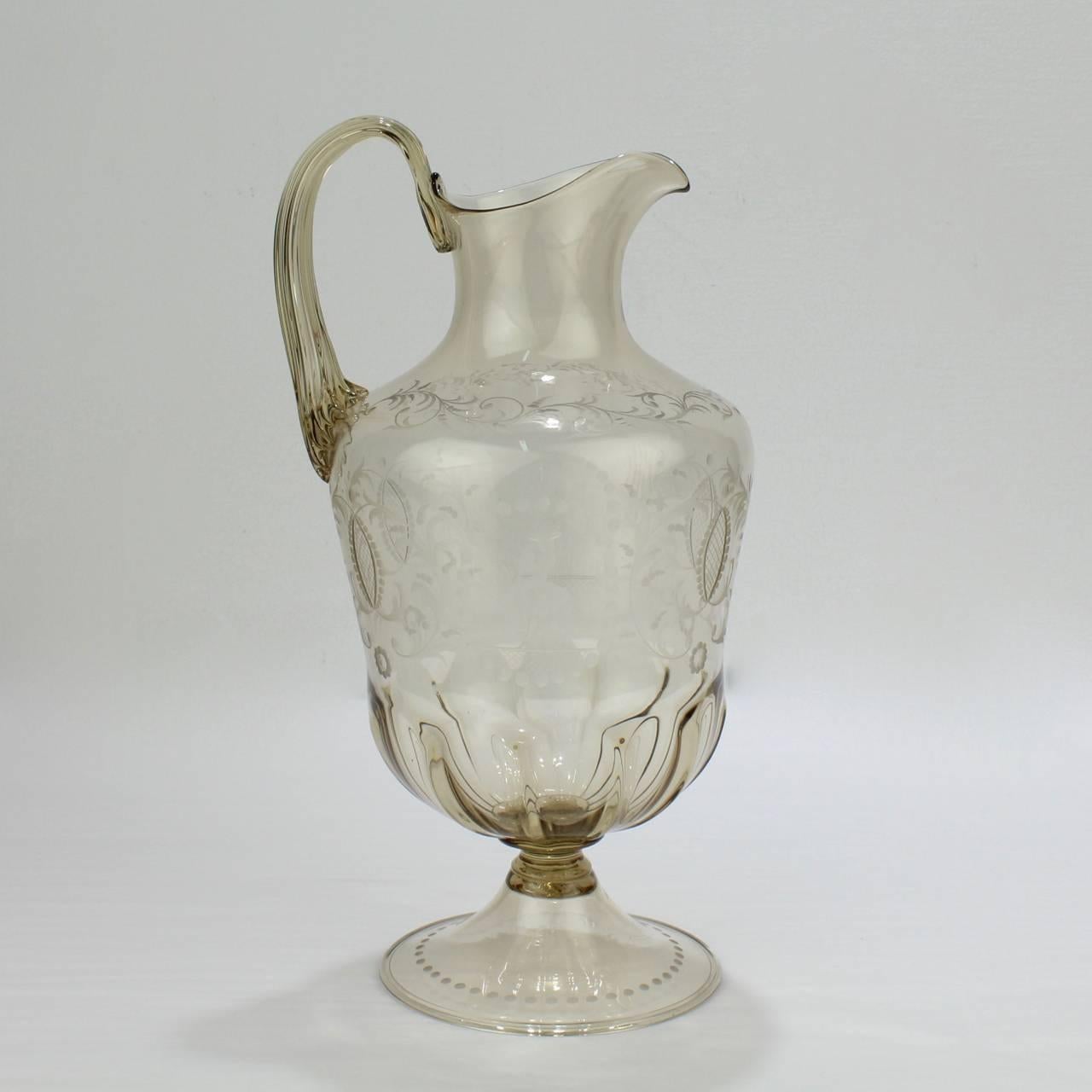 A good vintage Venetian glass wine ewer or water pitcher.

Manufactured by Pauly and Co. in Venice, Italy in a light amber blown glass with an applied handle and a central body with Renaissance style etching resting on a trumpet-form foot.

A rare