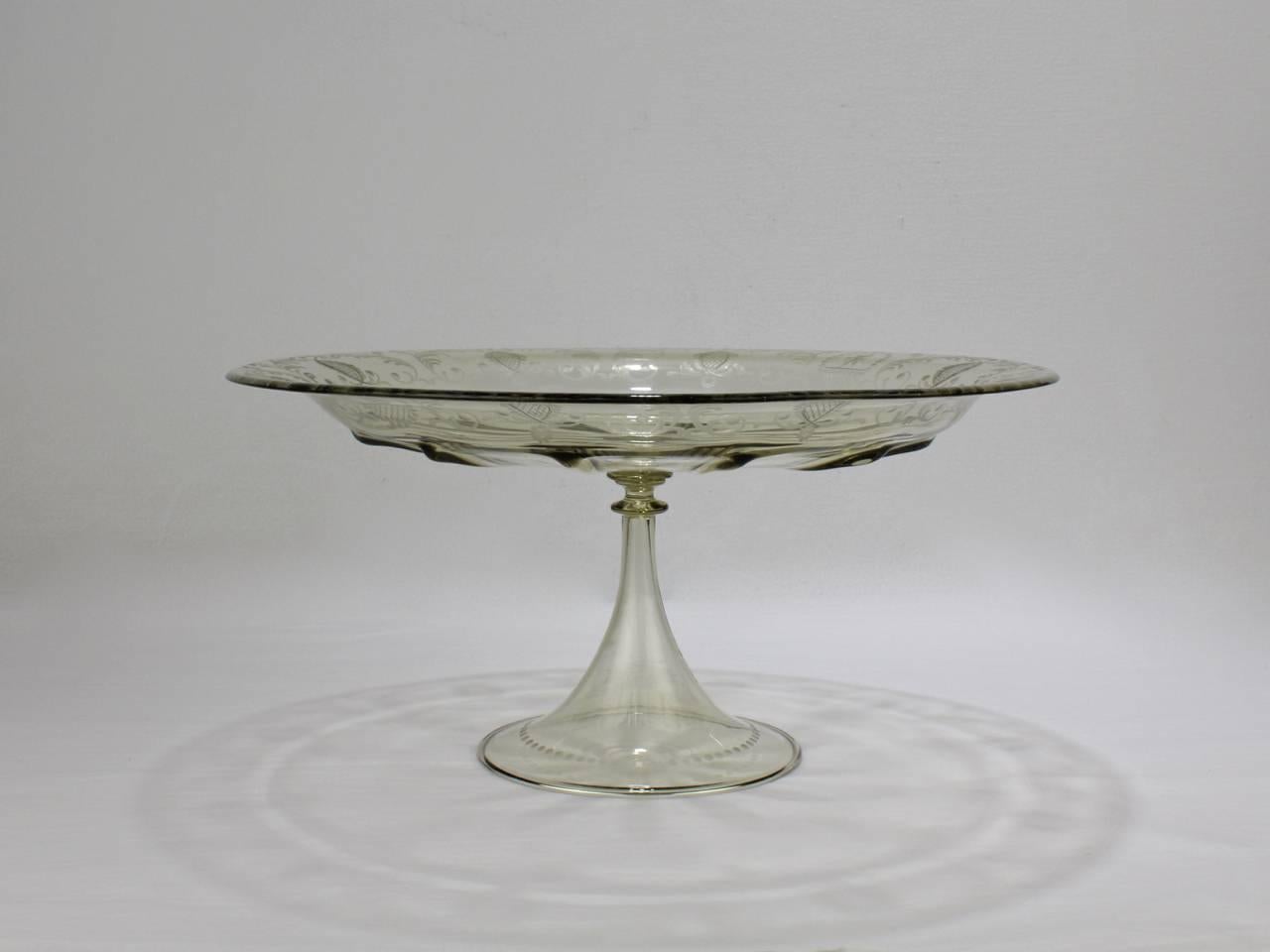 A good vintage Venetian glass tazza or cake stand.

Well-scaled as a table centerpiece.

Manufactured by Pauly and Co. of Venice, Italy in a light amber blown glass with a broad rim with Renaissance style etching resting on a trumpet-form