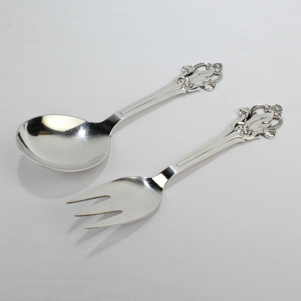 A good, period Danish Modern sterling silver salad set by Cohr.

With grape, leaf, and flower decoration to the finials. As best we know, the pattern is unnamed. From the beginning of the 20th century, Cohr was a competitor of Georg Jensen Co.