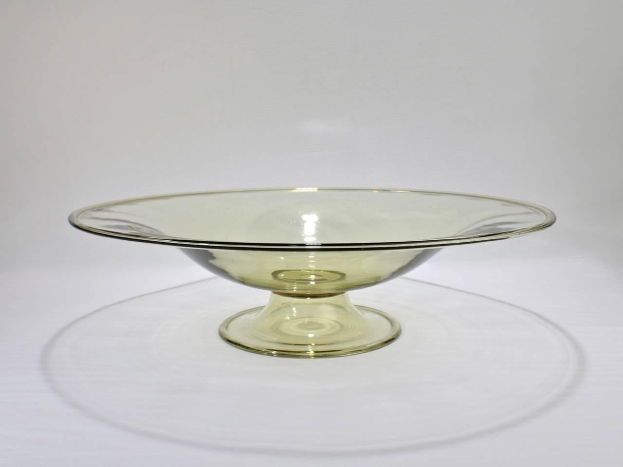 A very large midcentury Murano or Venetian amber color glass footed bowl.

Perfect as a table centerpiece.

Likely by Salviati.

Measure: Diameter ca. 16 3/4 in.

Items purchased from David Sterner Antiques must delight you. Purchases may be