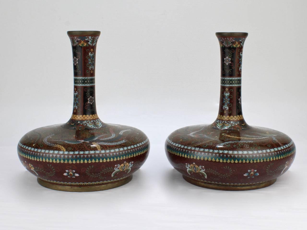 A good pair of antique Japanese large-scale Meiji period cloisonné vases.

Of very rare mallet or suppressed bottle form with rich goldstone ground and phoenix decoration. 

Measures: Height circa 9 3/4 in.

Purchases may be returned for any