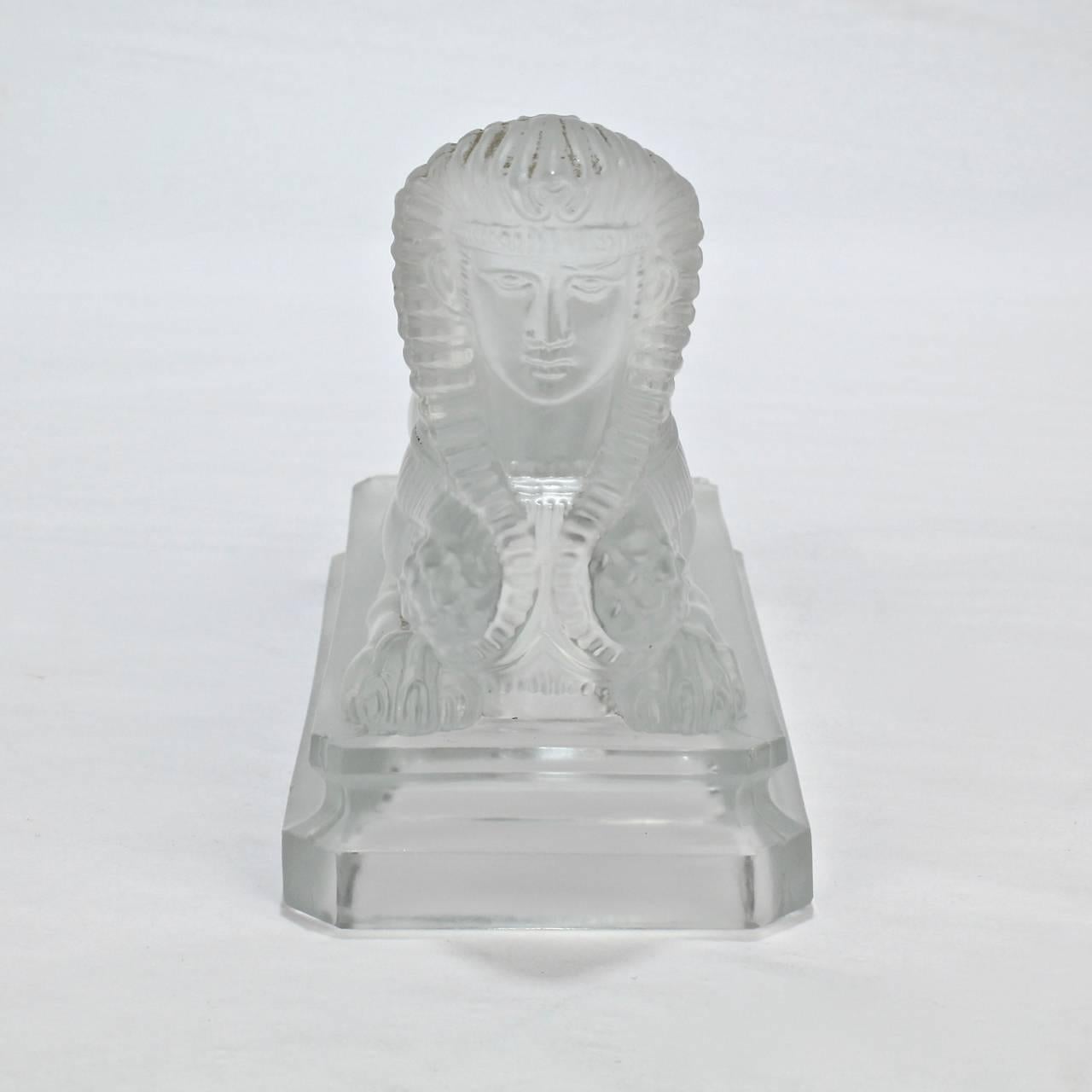 A rare antique pressed glass model of a sphinx by Saint Louis - the premiere French 19th and 20th century glass house.

Purportedly, Saint Louis exhibited a similar sphinx model the 1876 World's Fair Centennial Exhibition. A limited number of