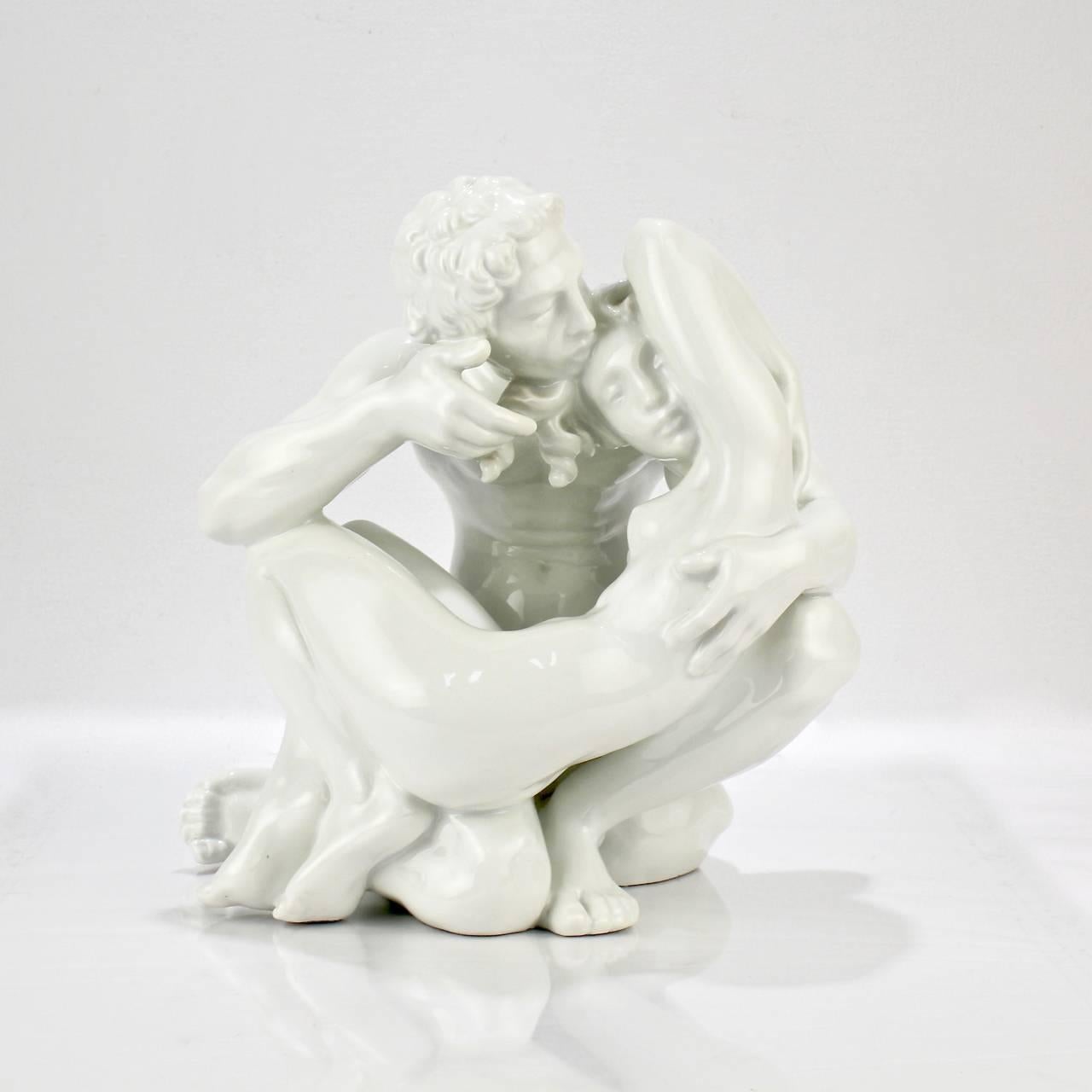An alluring Art Deco period Danish blanc-de-chine porcelain figurine of tenderly entwined lovers by Jen Jacob Bregno for Dahl Jensen.

Entitled: Paradise

Base bears a green underglaze factory mark and model no. 1184.

Measure: Height ca. 10