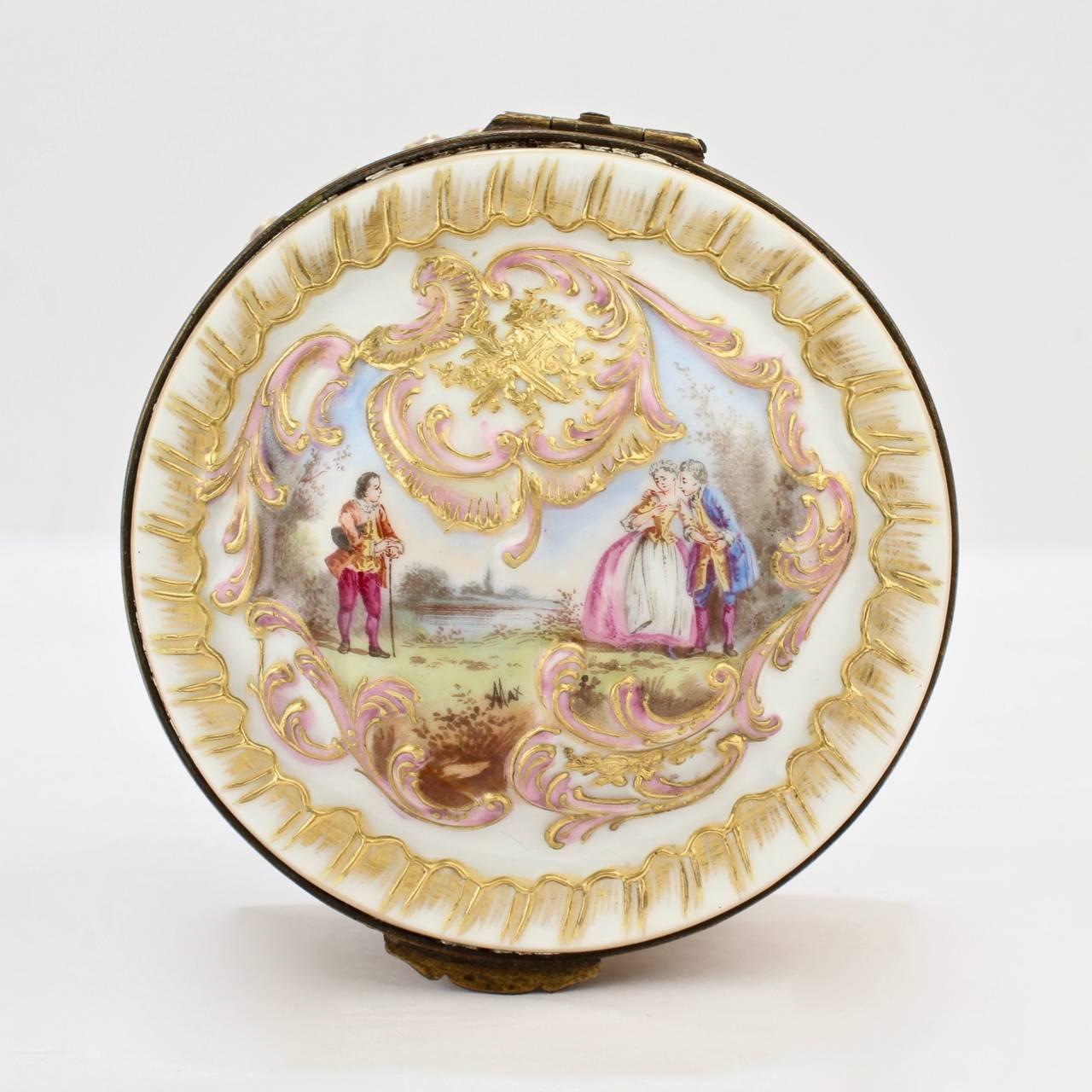 A compelling round 19th century Paris porcelain box by Bloch and Bourdois.

With raised gold decoration, hand-painted vignettes and floral sprays, and a gilt bronze mount.

Base bears a blue underglaze factory mark.

Measures: Diameter ca. 3