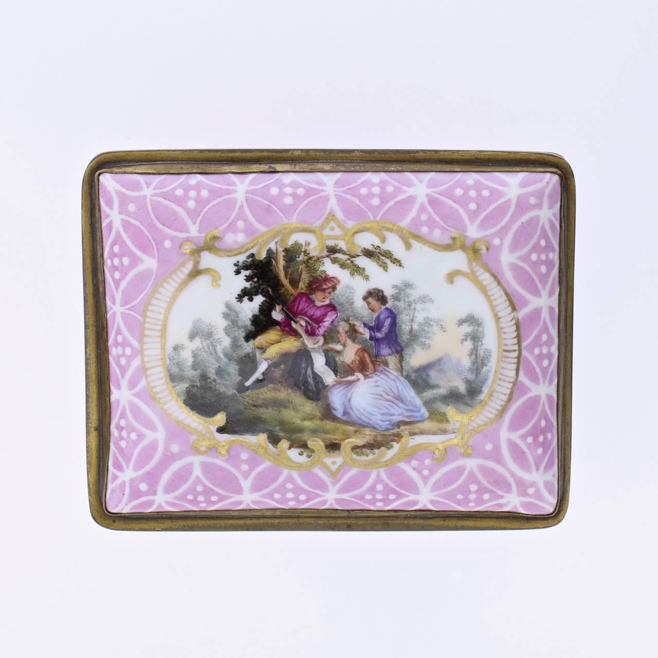 A fine antique English South Staffordshire or Battersea enamel table snuff box. 

With a pink ground and white enamel latticework decoration throughout. Each side has a cartouche with classical lover's scenes. The interior of the lid has a