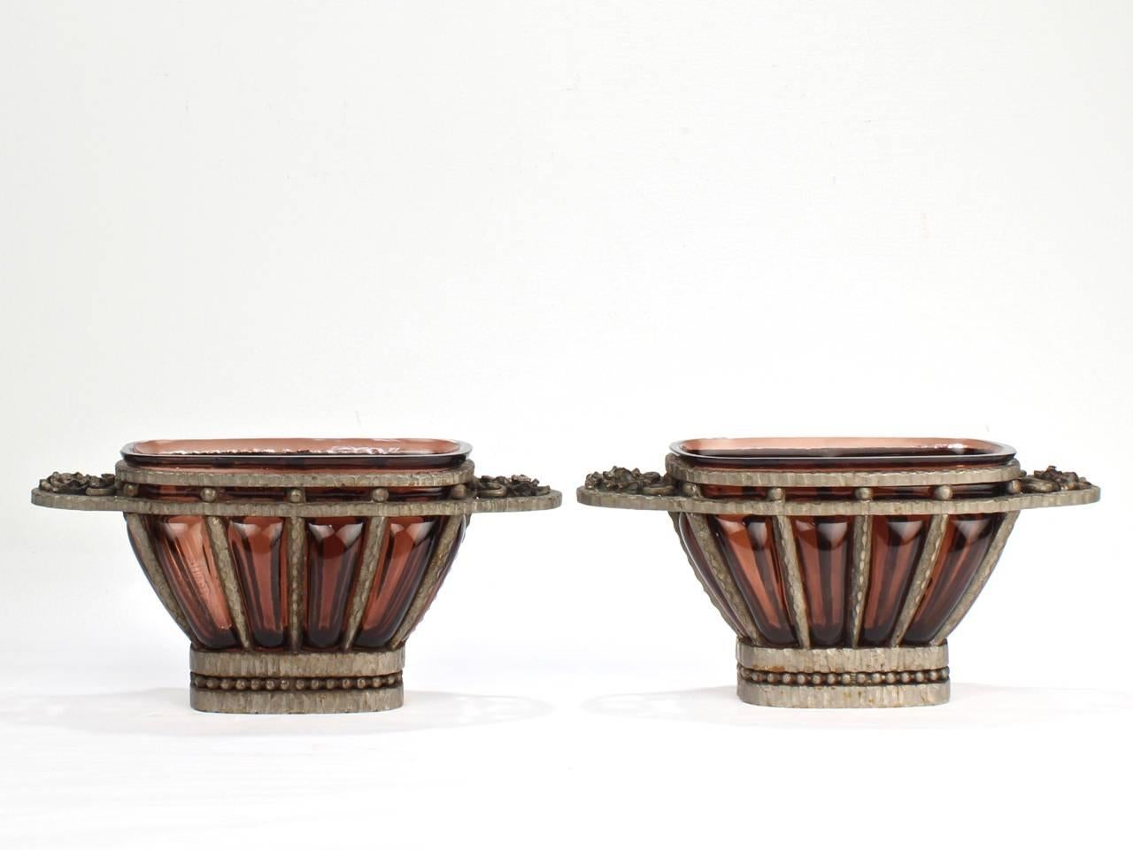 Una splendida coppia di cachepot in vetro artistico e ferro battuto nichelato di Muller Freres.

Risale al periodo Art Deco.

Nello stile di Edgar Brandt o Louis Majorelle con vetro soffiato ametista o viola in un cachepot o cesto per fioriere