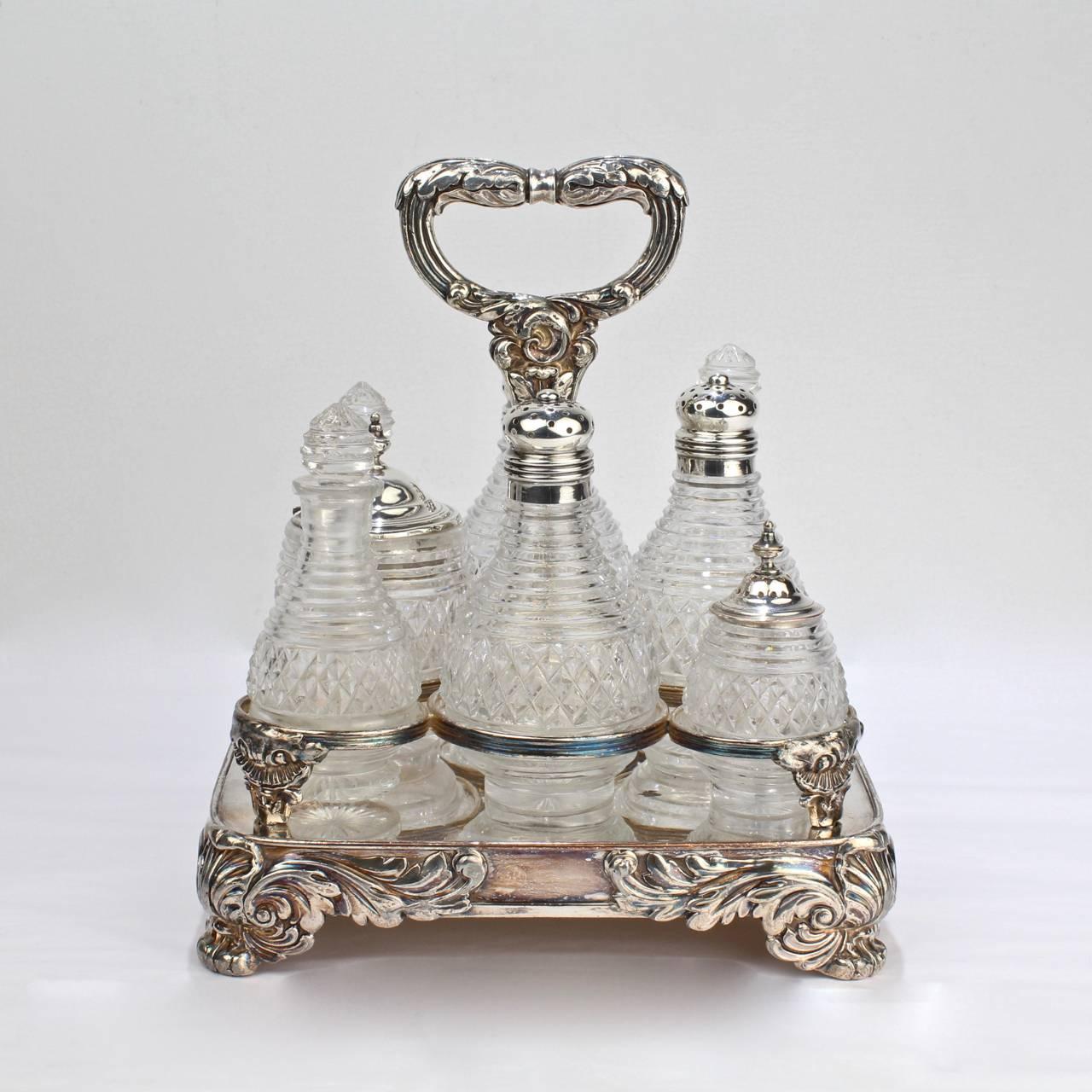 A rare English George III Old Sheffield plate cruet stand with cut-glass bottles by Matthew Boulton.

Consisting of three stoppered bottles, three bottles with pierced shaker tops, and two lidded jars each in a ringed section of the silver plated