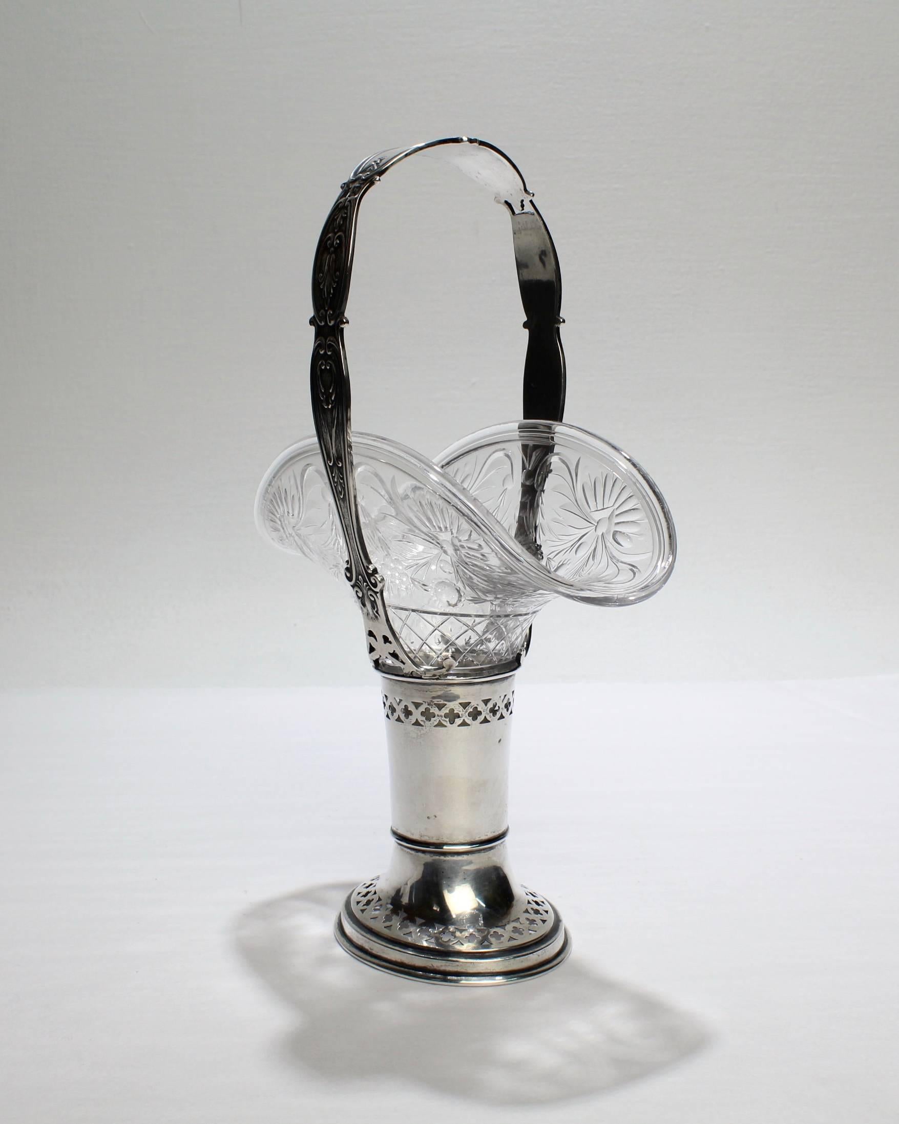 A fine, antique Gorham sterling silver and cut-glass handled basket. The glass insert has etched engraving and the basket has embossed and pierced decoration. An excellent example of an unusual form!

The base bears marks for Gorham, Sterling, and