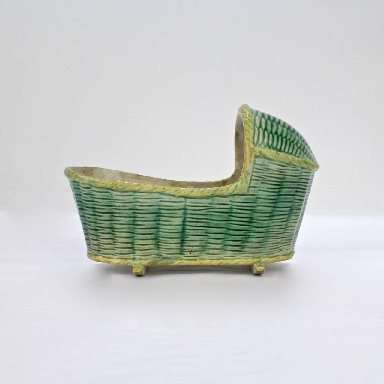 A late 18th or early 19th century English Prattware baby's cradle in a rare large size.

Decorated with an overall basket weave pattern and a yellow and green glaze.

Measures: Length ca. 5 7/8 in.

Items purchased from this dealer must