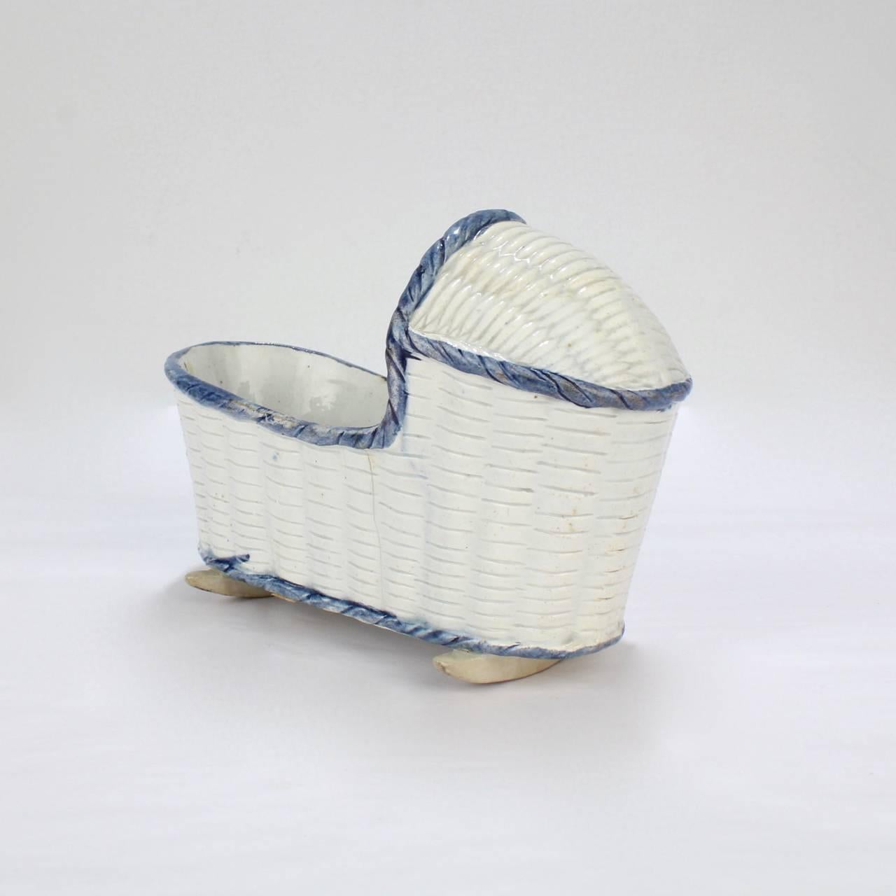 A rare, large English pearlware or Staffordshire pottery cradle.

Decorated with an overall basketweave pattern and blue highlights,

circa 1800.

Measures: Length ca. 5 5/8 in.

Items purchased from this dealer must delight you. Purchases