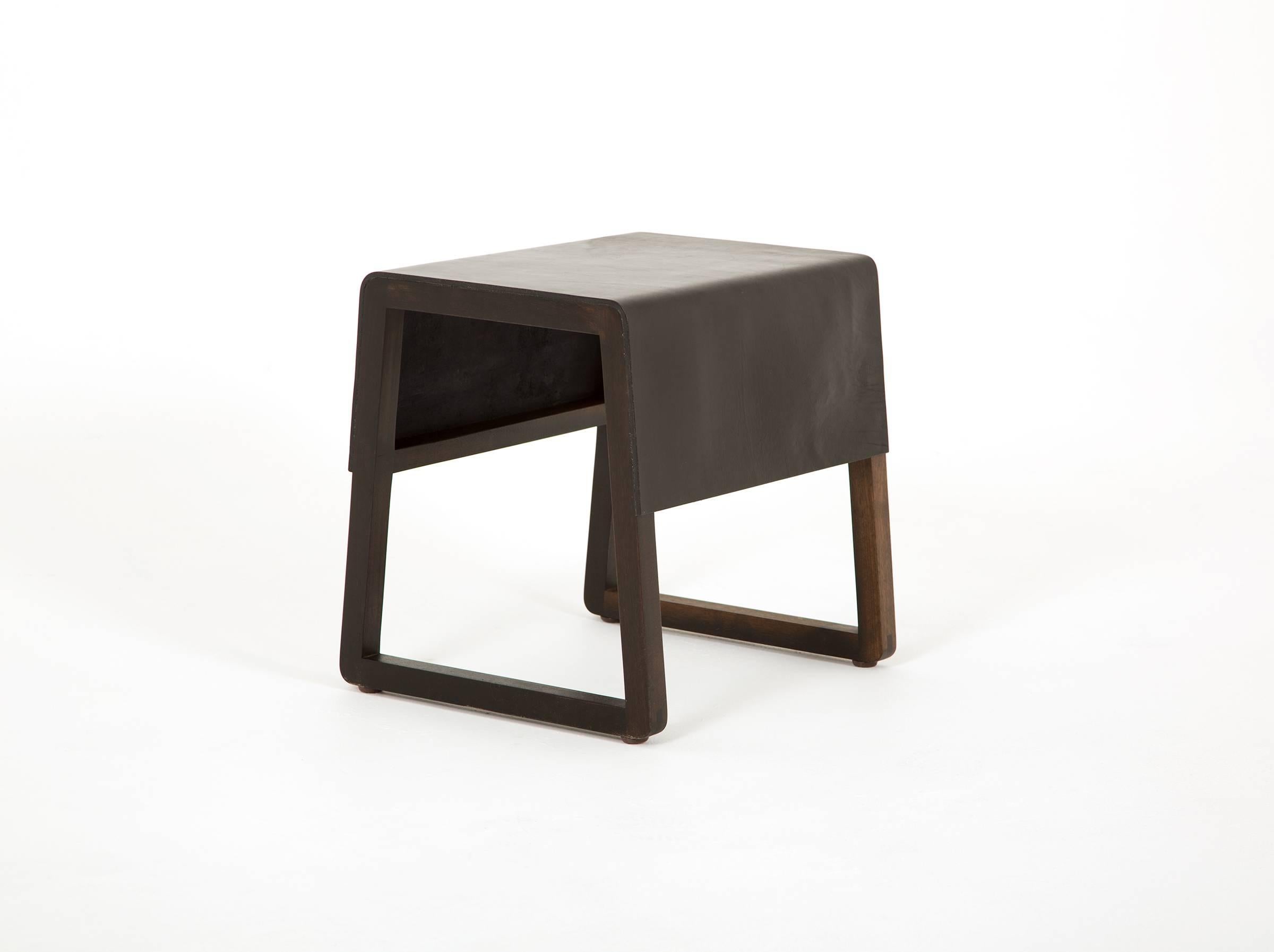 Leather top low stool.

Made of oxidized walnut oak and black vegetable tanned leather.

Designed and built by Max Greenberg for Works Progress. 

Underside labeled with the Works Progress logo.

Other wood selections or additional stools
